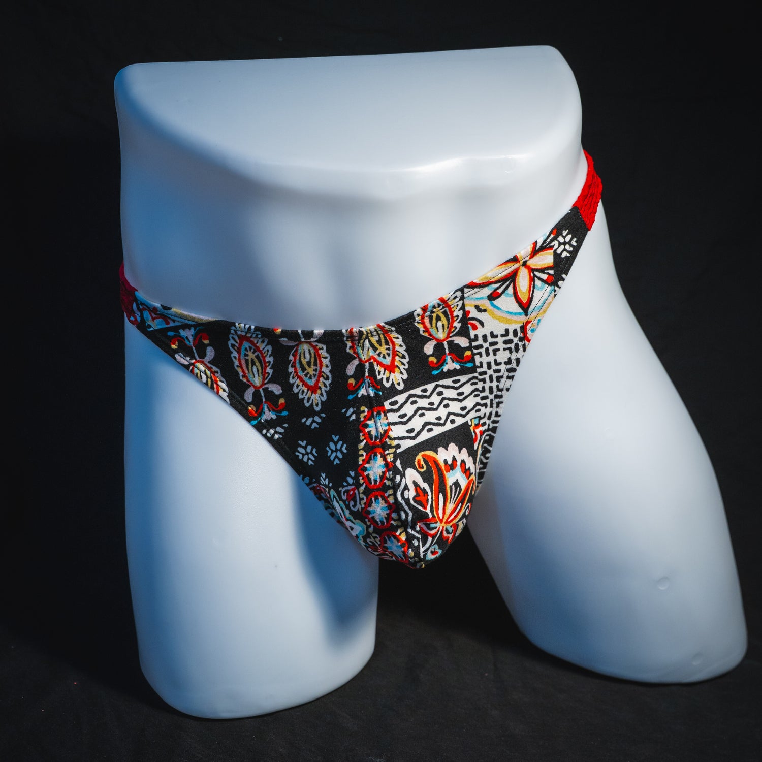 Men's bohemian red thong underwear, classic cut, full front view.