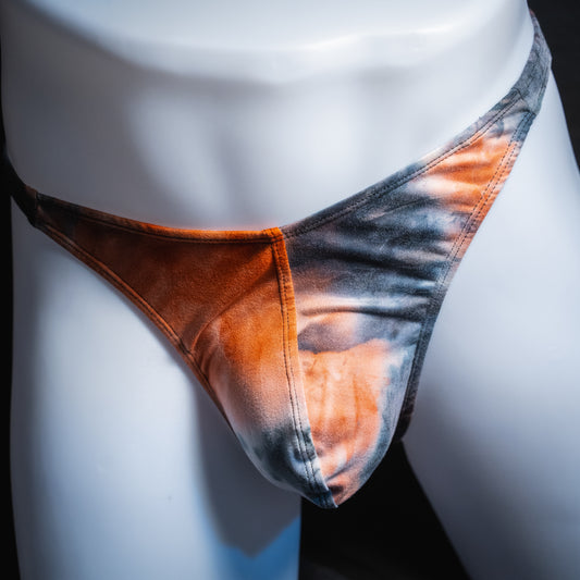 Men's black and red tie dye thong, classic cut, front view.