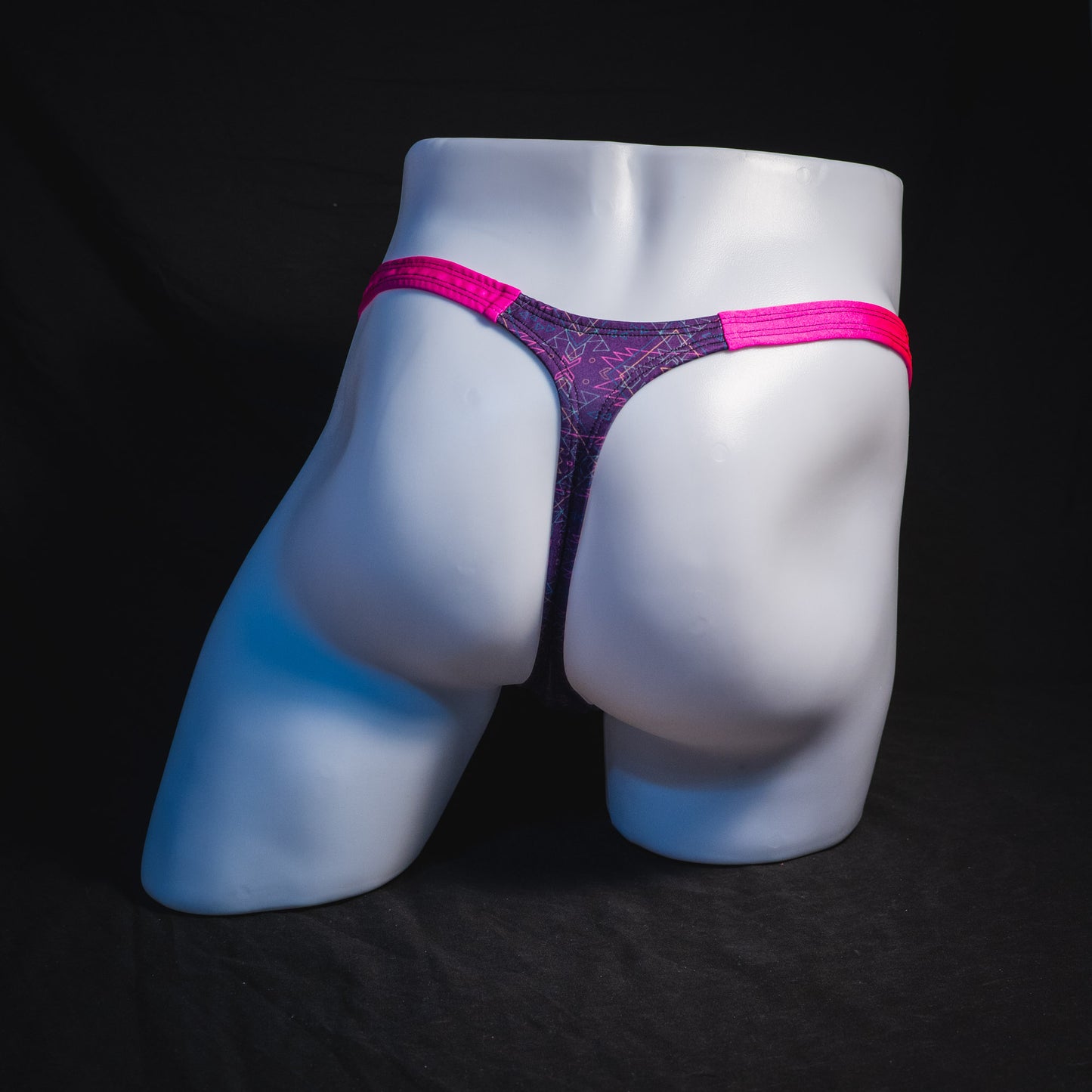 Men's pink and purple thong underwear, classic cut, full rear view.