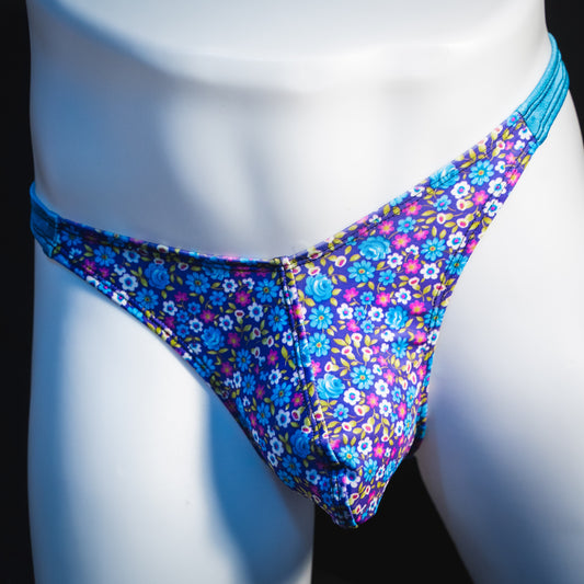 Men's blue and purple flower patch thong underwear, classic cut, front view.