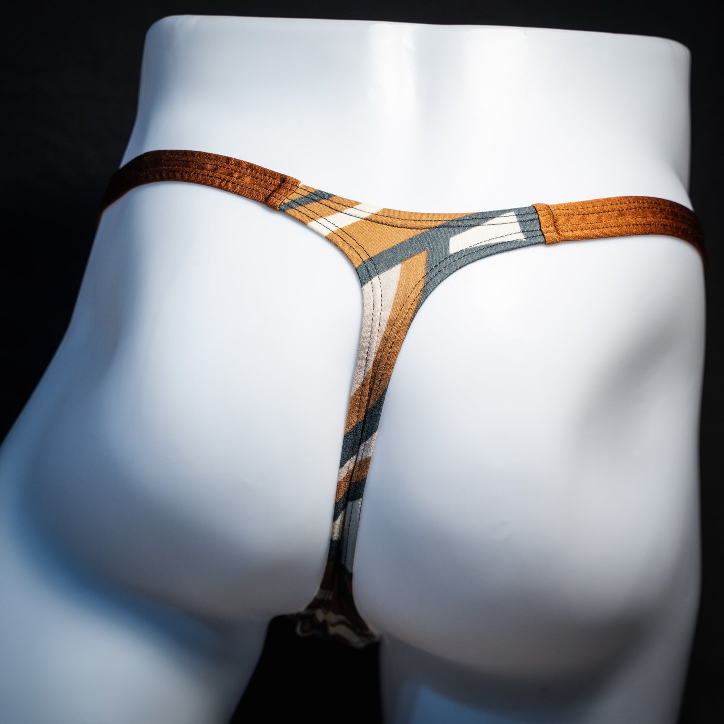 Men's brown and tan thong underwear, classic cut, rear view.
