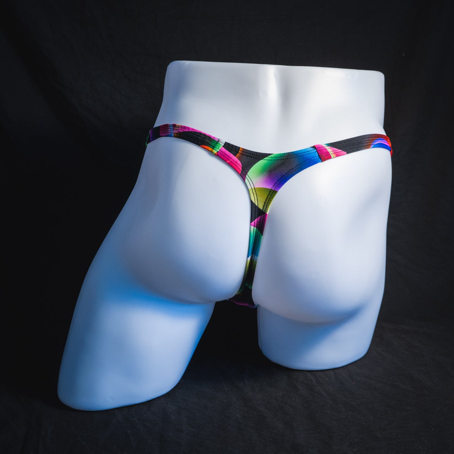 Men's colorful thong underwear, tower cut, full rear view.