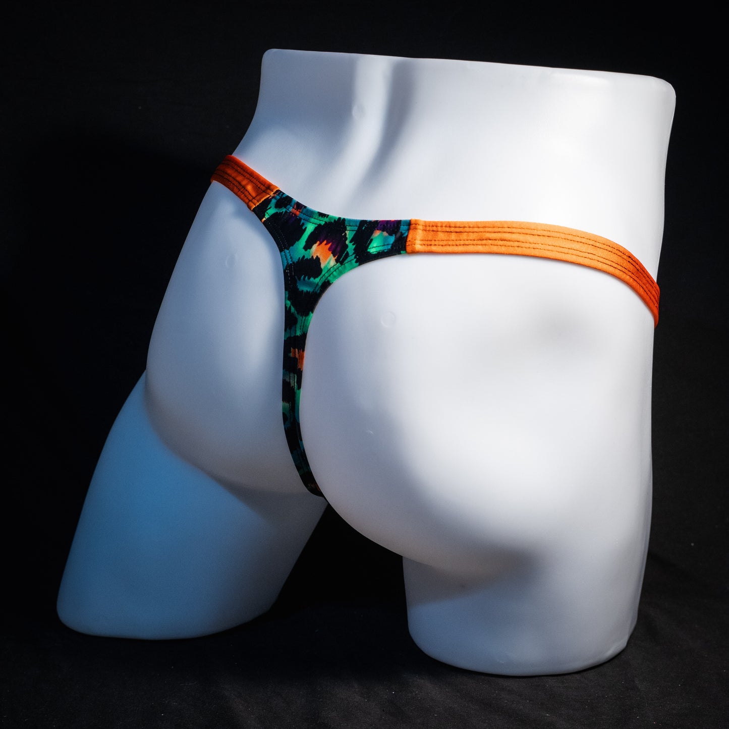 Men's green cheetah thong underwear, classic cut, rear view.
