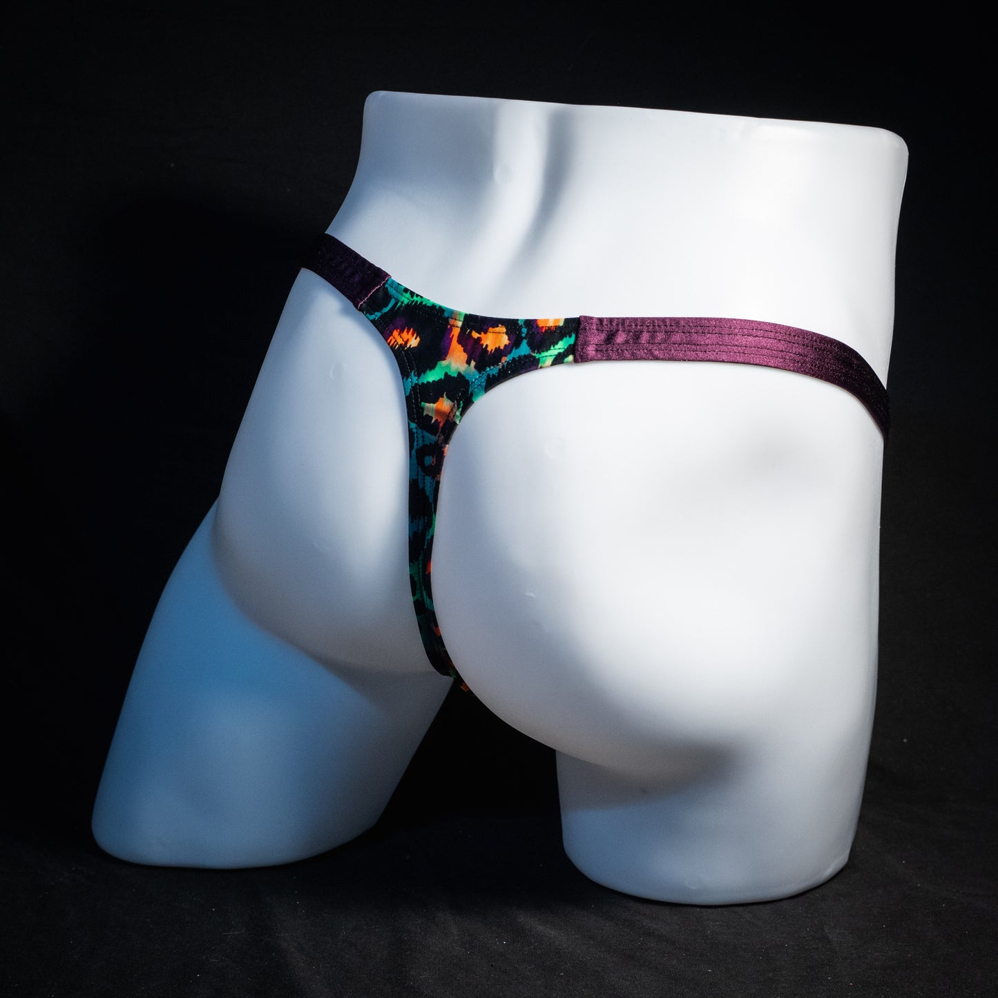 Men's green cheetah thong underwear, classic cut, rear view.