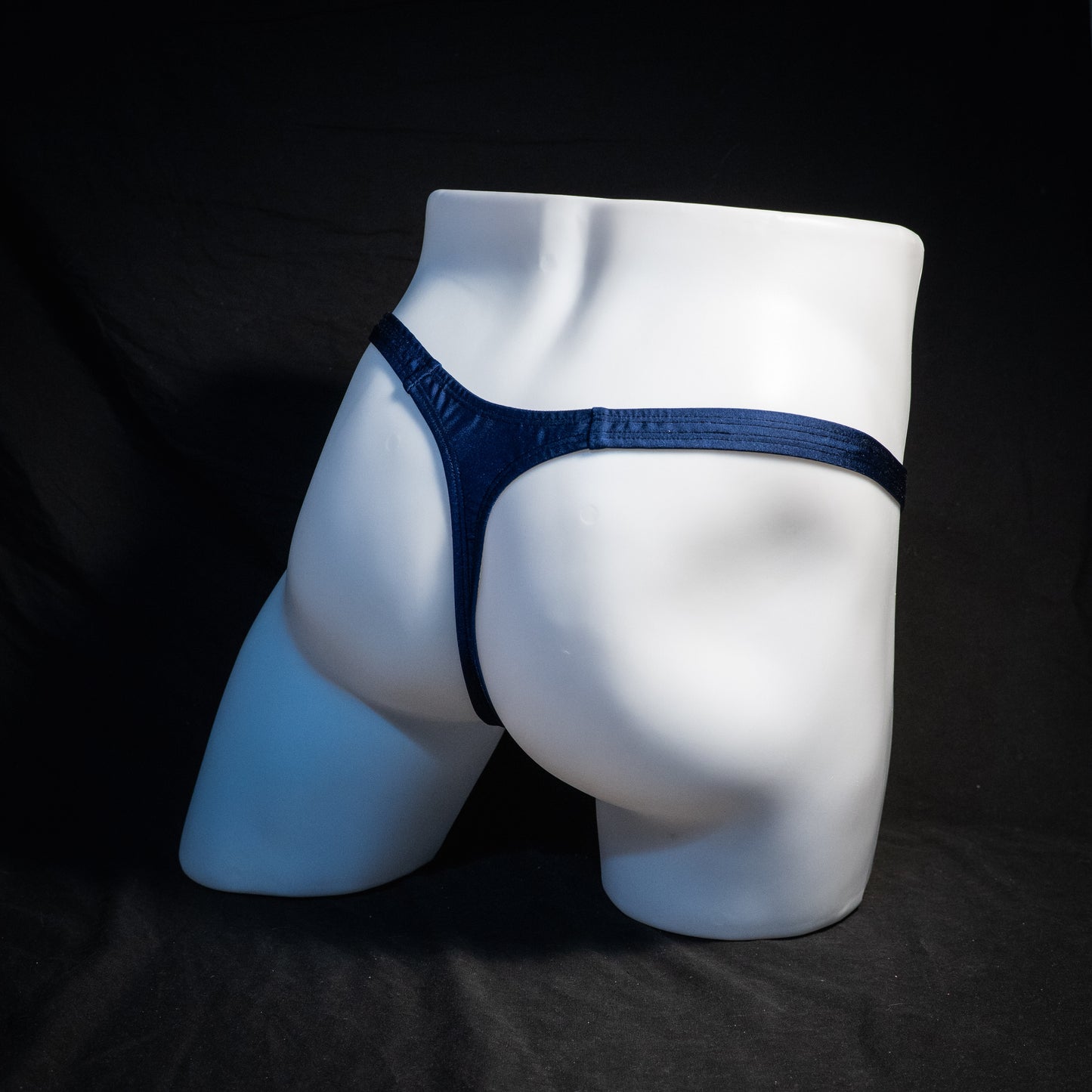 Men's navy blue thong underwear, classic cut, rear view.