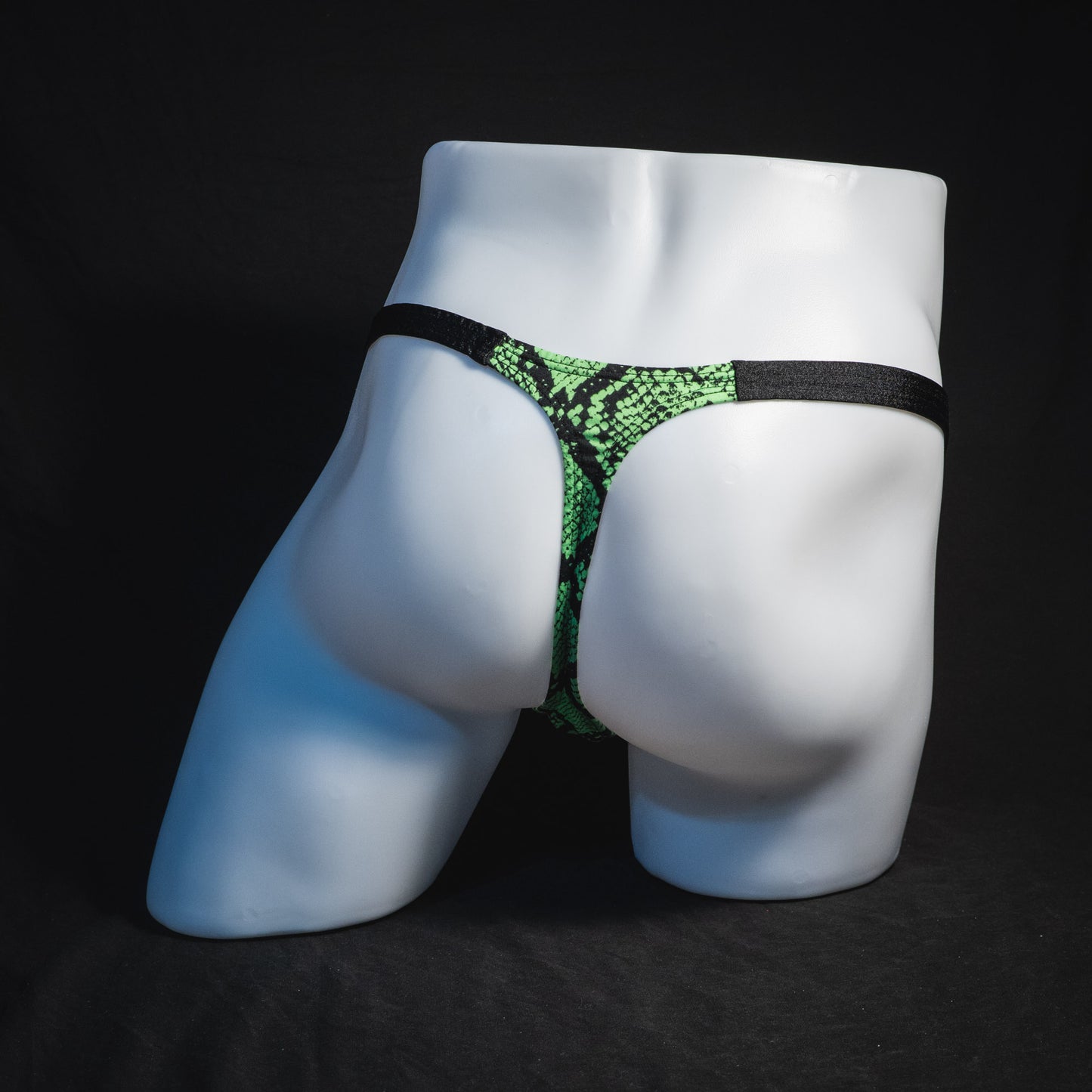 Men's neon green snakeskin thong underwear, classic cut, full rear view.