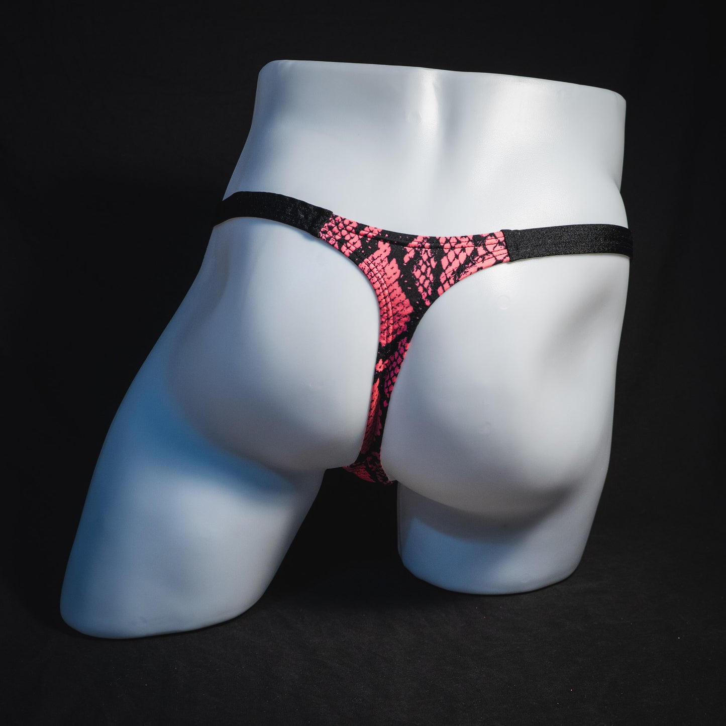 Men's neon pink snakeskin thong underwear, classic cut, full rear view.