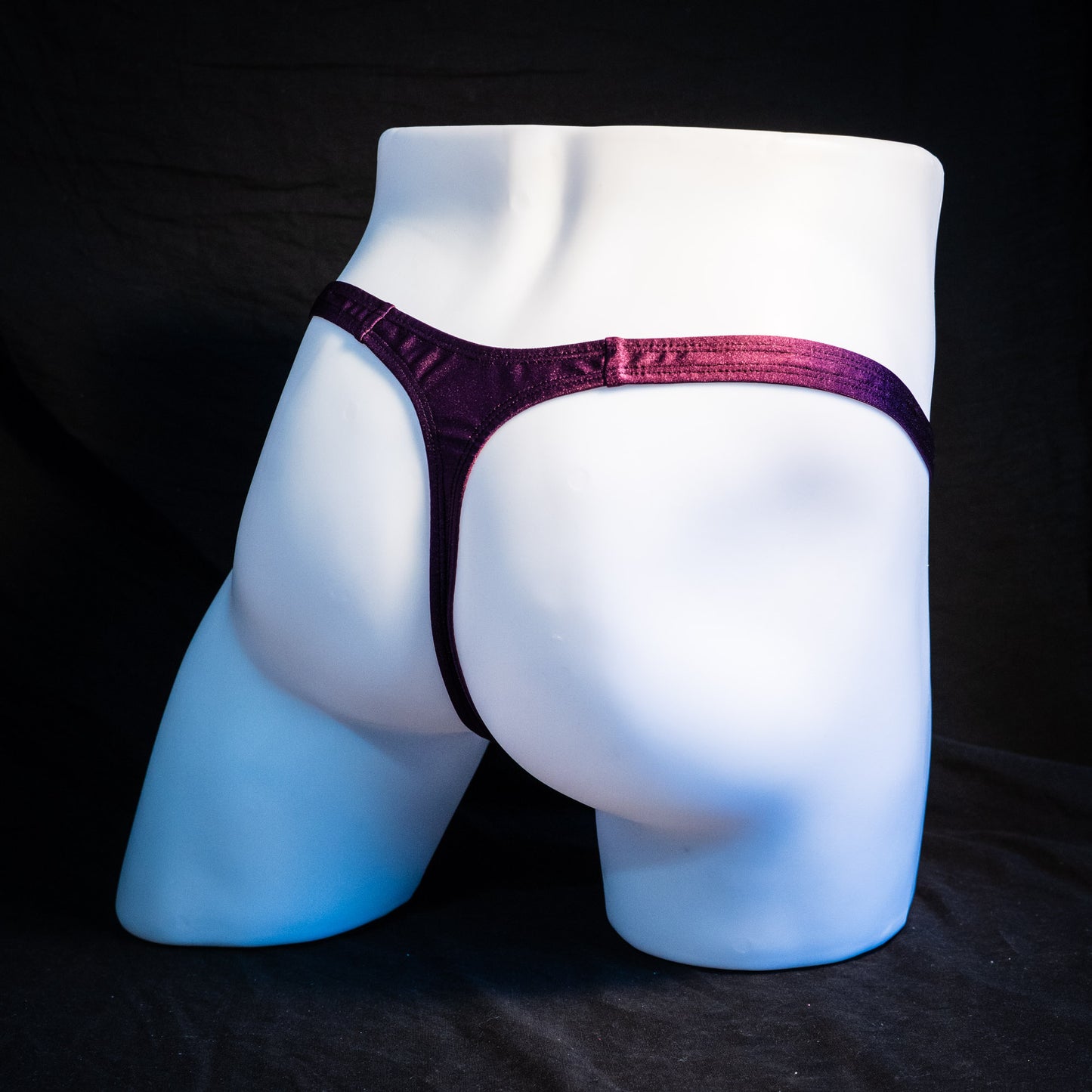 Men's half mesh and purple thong underwear, classic cut, full rear angled view.