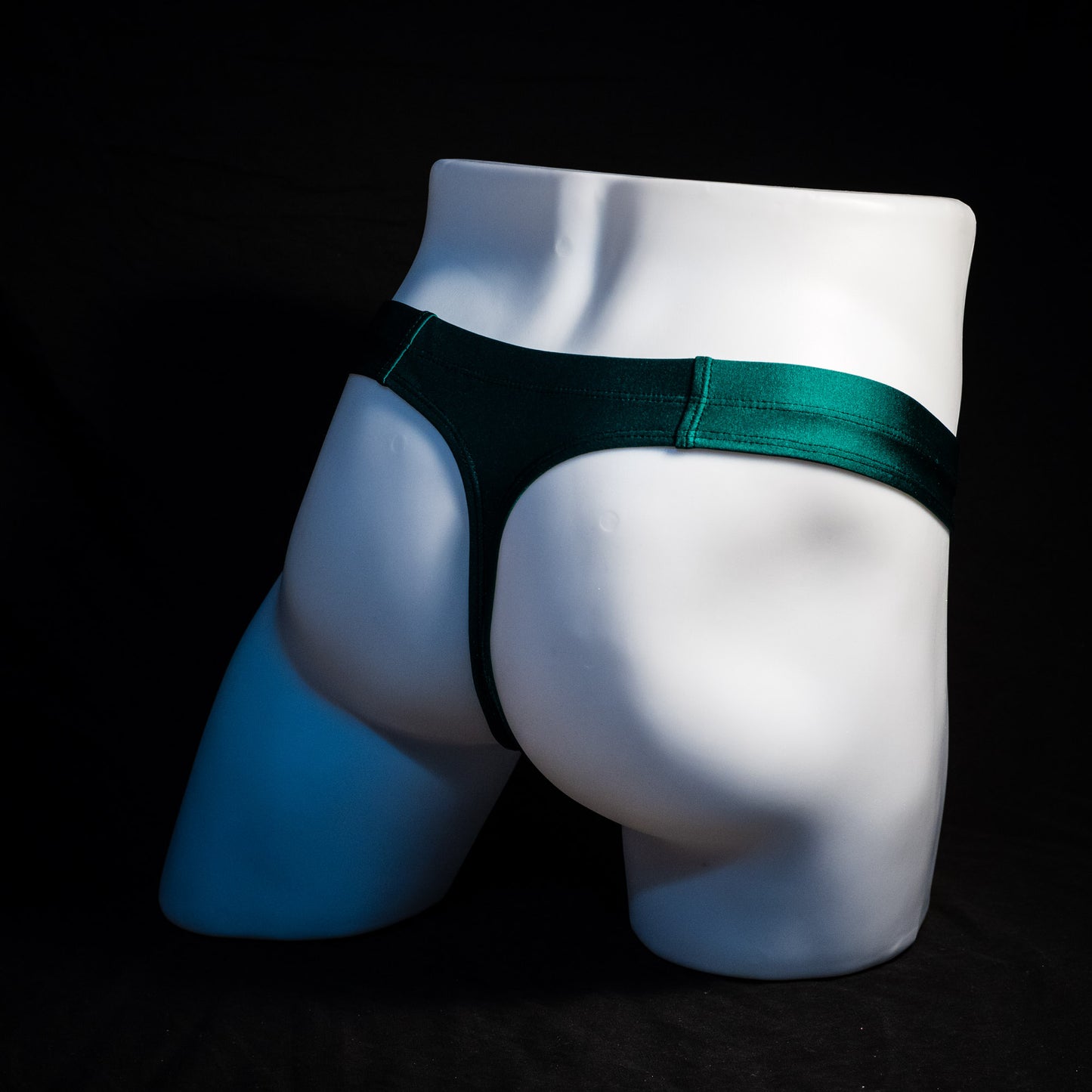 Men's forest green thong underwear, full angled rear view.