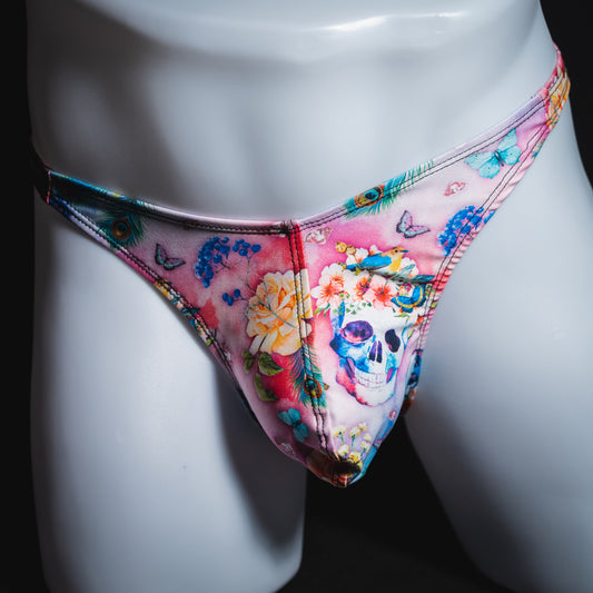 Men's pink skulls and floral thong underwear, classic cut, front view.
