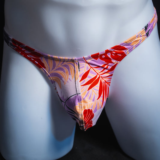 Men's vintage purple Hawaiian floral thong, slim cut, front view.