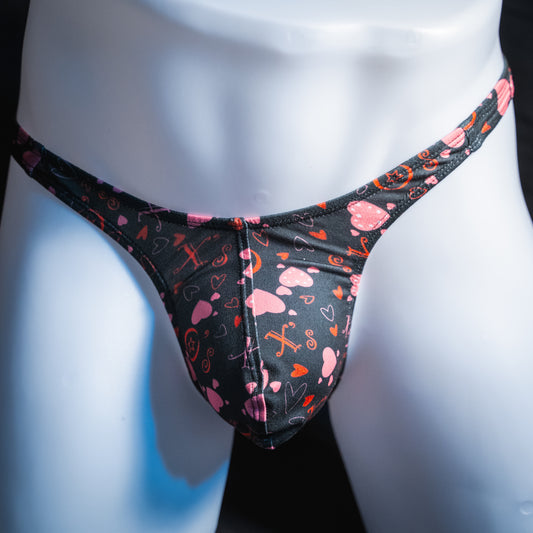 Men's black with read heart Valentines day thong, slim cut, front view.