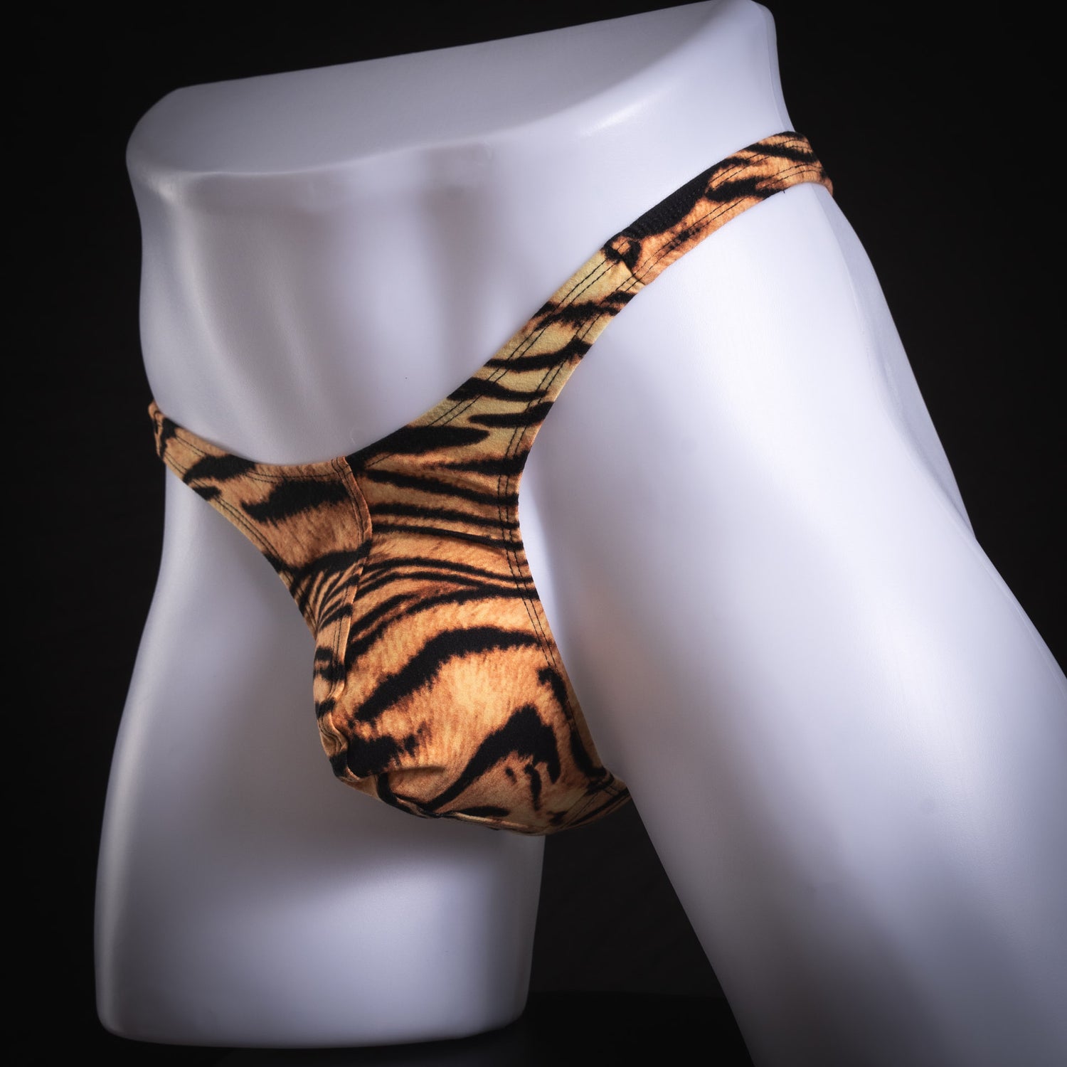 men's thong underwear, tiger stripe pattern, soft polyester, slim cut, angled front view.
