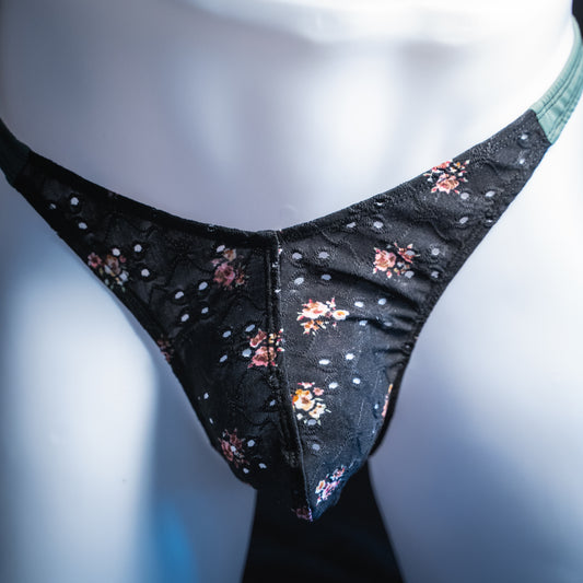 handmade mens thong underwear, black floral eyelet pattern, soft polyester material, classic cut variation, front view
