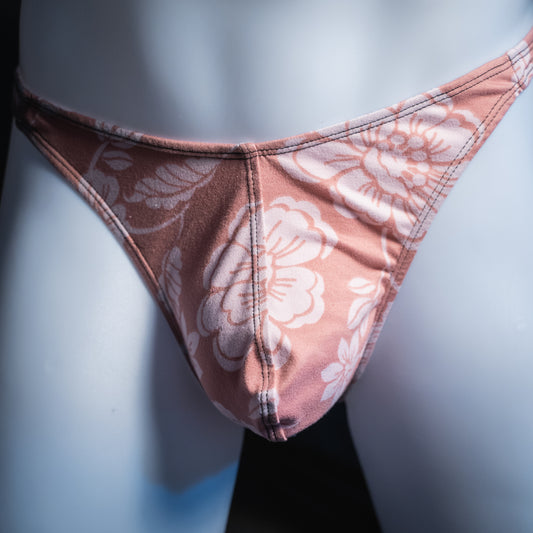 Men's mauve with white flowers thong, classic cut, front view.
