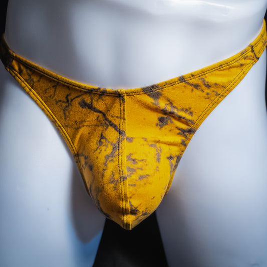 Men's yellow and black tie dye thong, classic cut, front view.