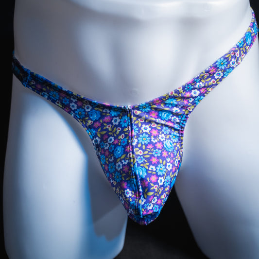 Men's purple and blue floral thong, sim cut, front view.