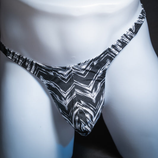 Mens' black and white zig zag striped thong, slim cut, front view.