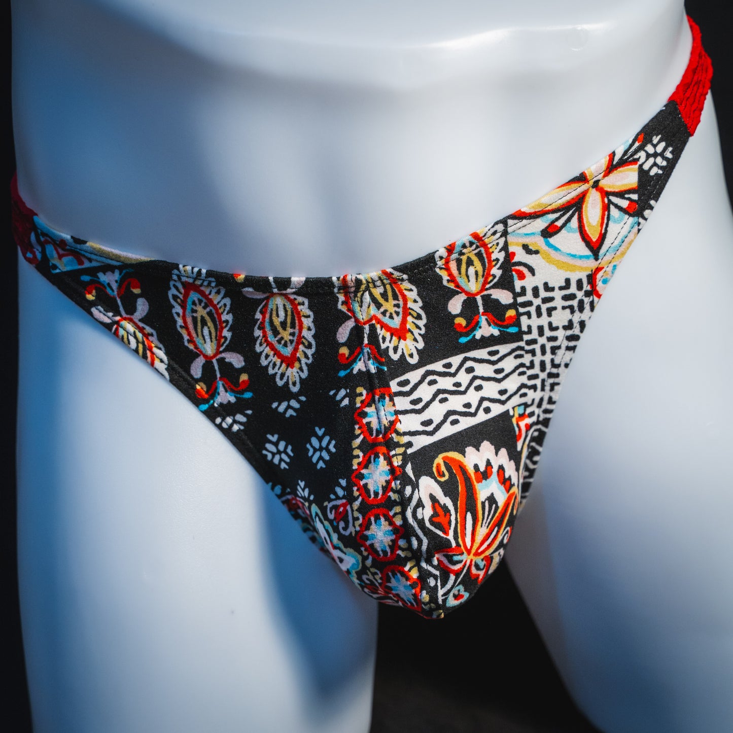 Men's bohemian red thong underwear, classic cut, front view.