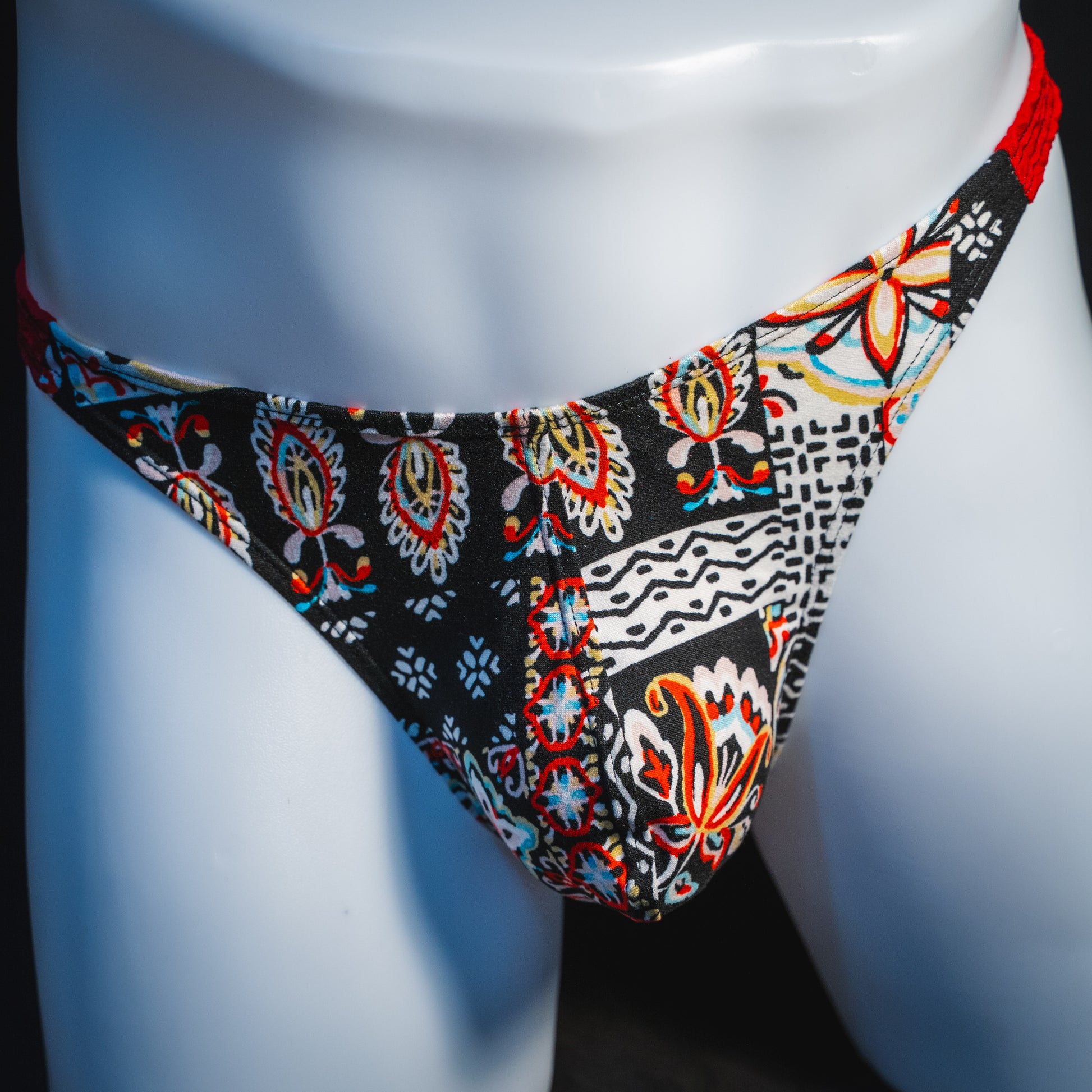 Men's bohemian red thong underwear, classic cut, front view.