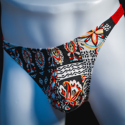 Men's bohemian red thong underwear, classic cut, angled front view.