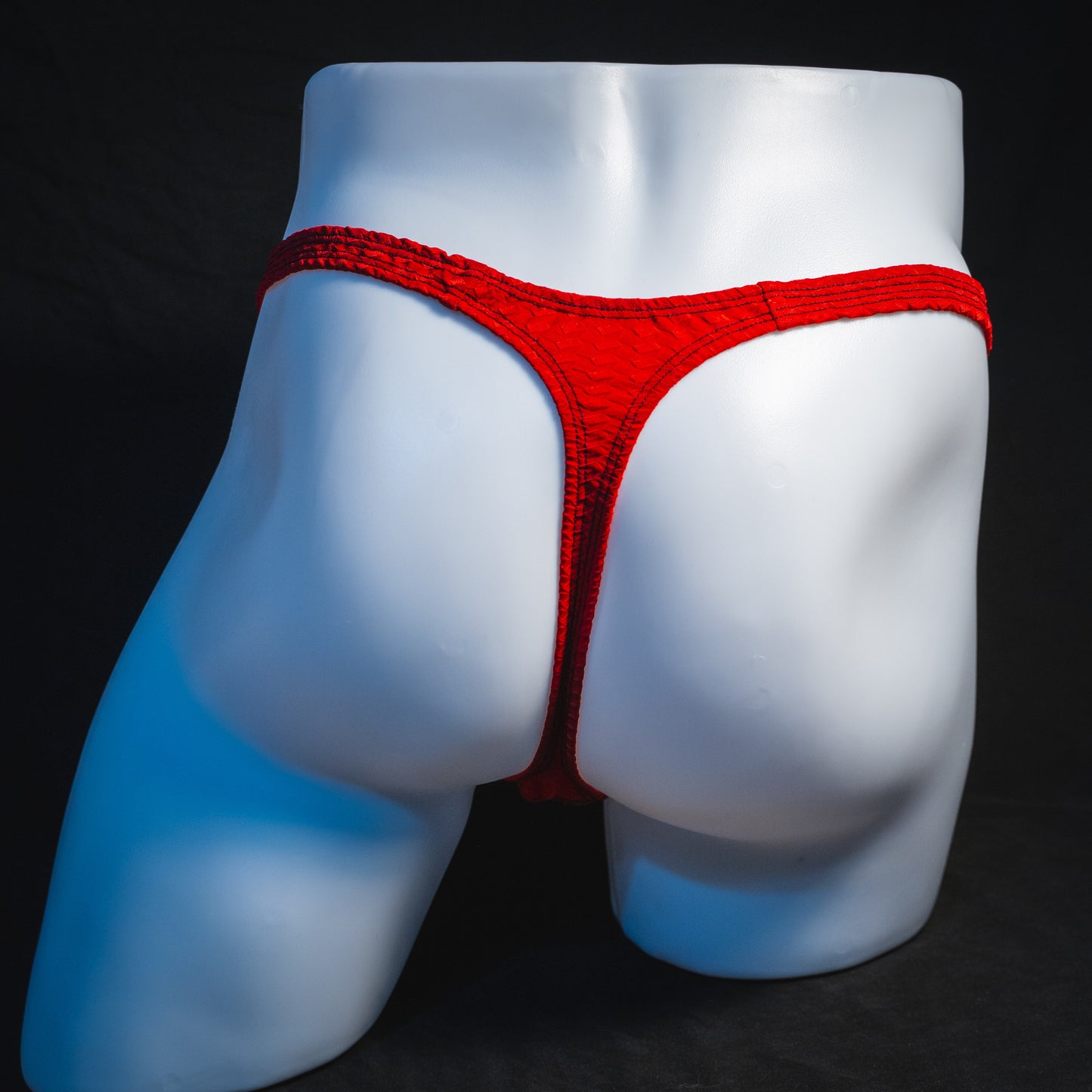 Men's bohemian red thong underwear, classic cut, full rear view.