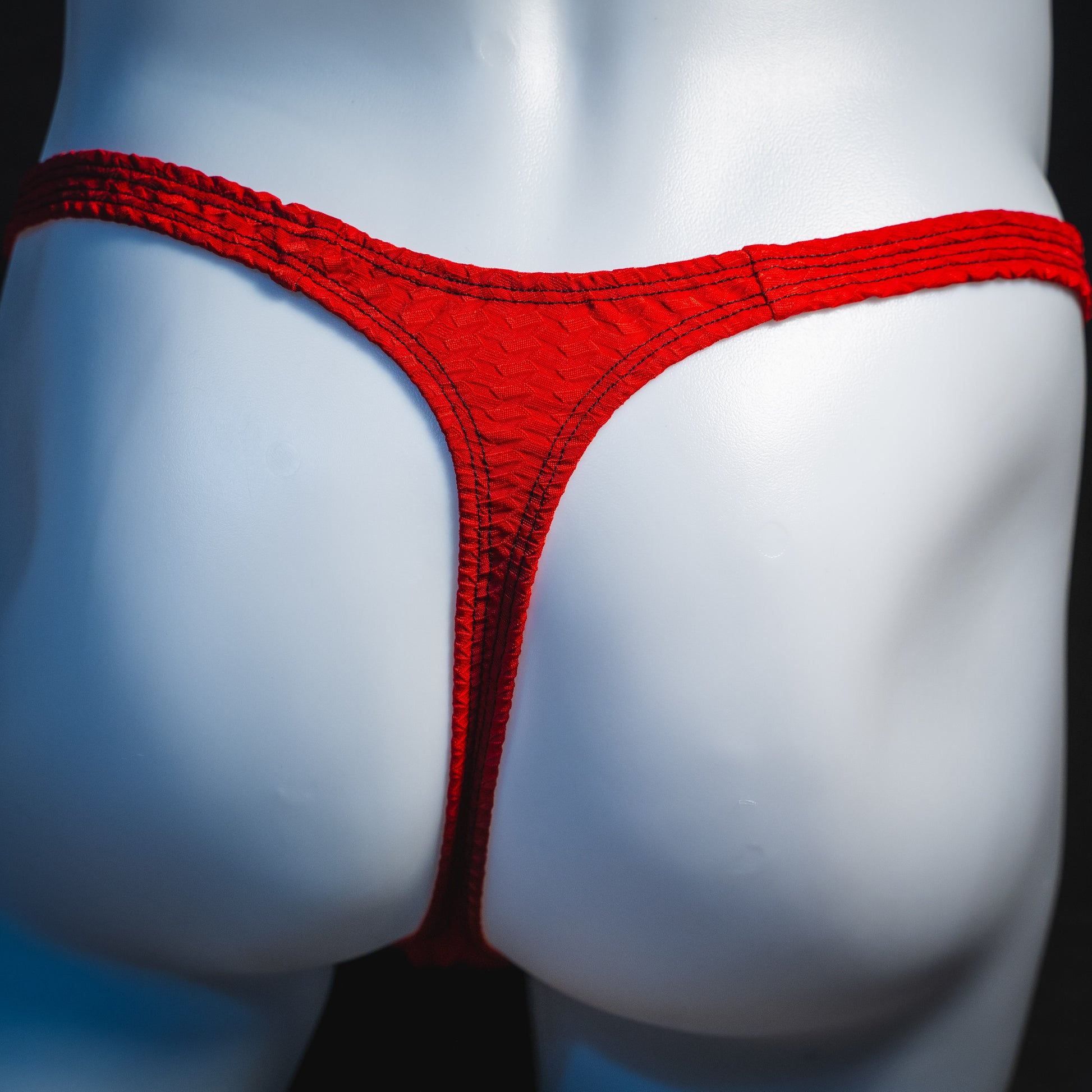 Men's bohemian red thong underwear, classic cut, rear view.