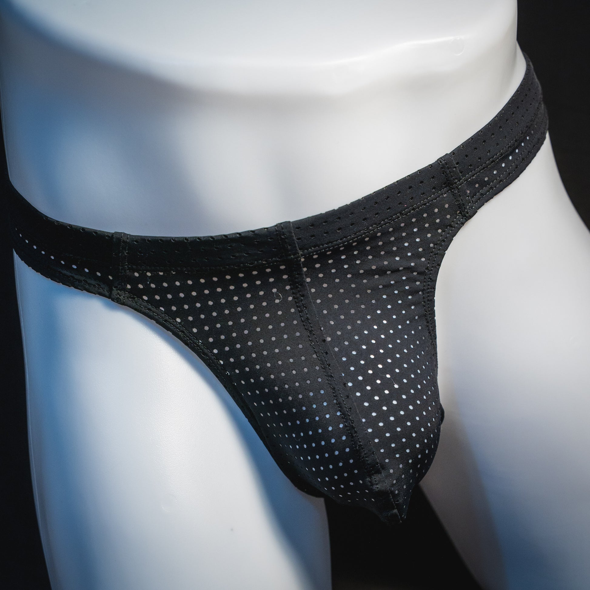 Men's black mesh pre-release thong underwear, front view.