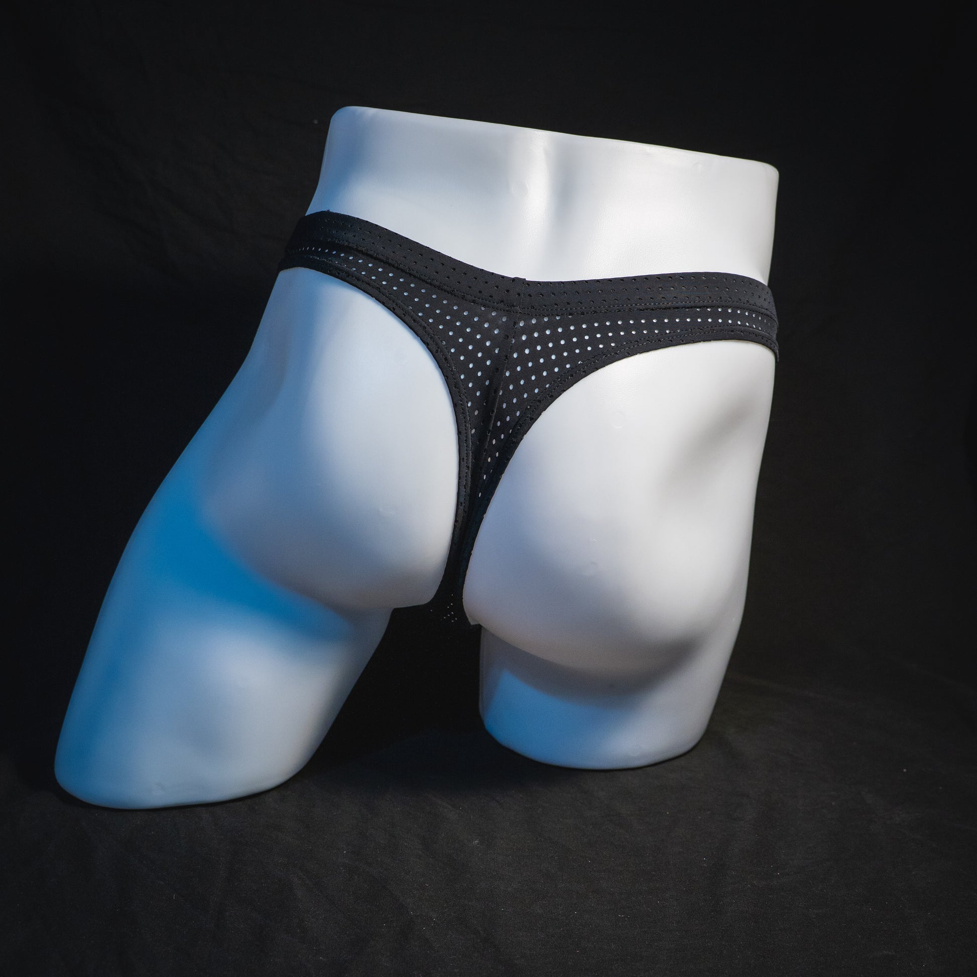 Men's black mesh pre-release thong underwear, full rear view.