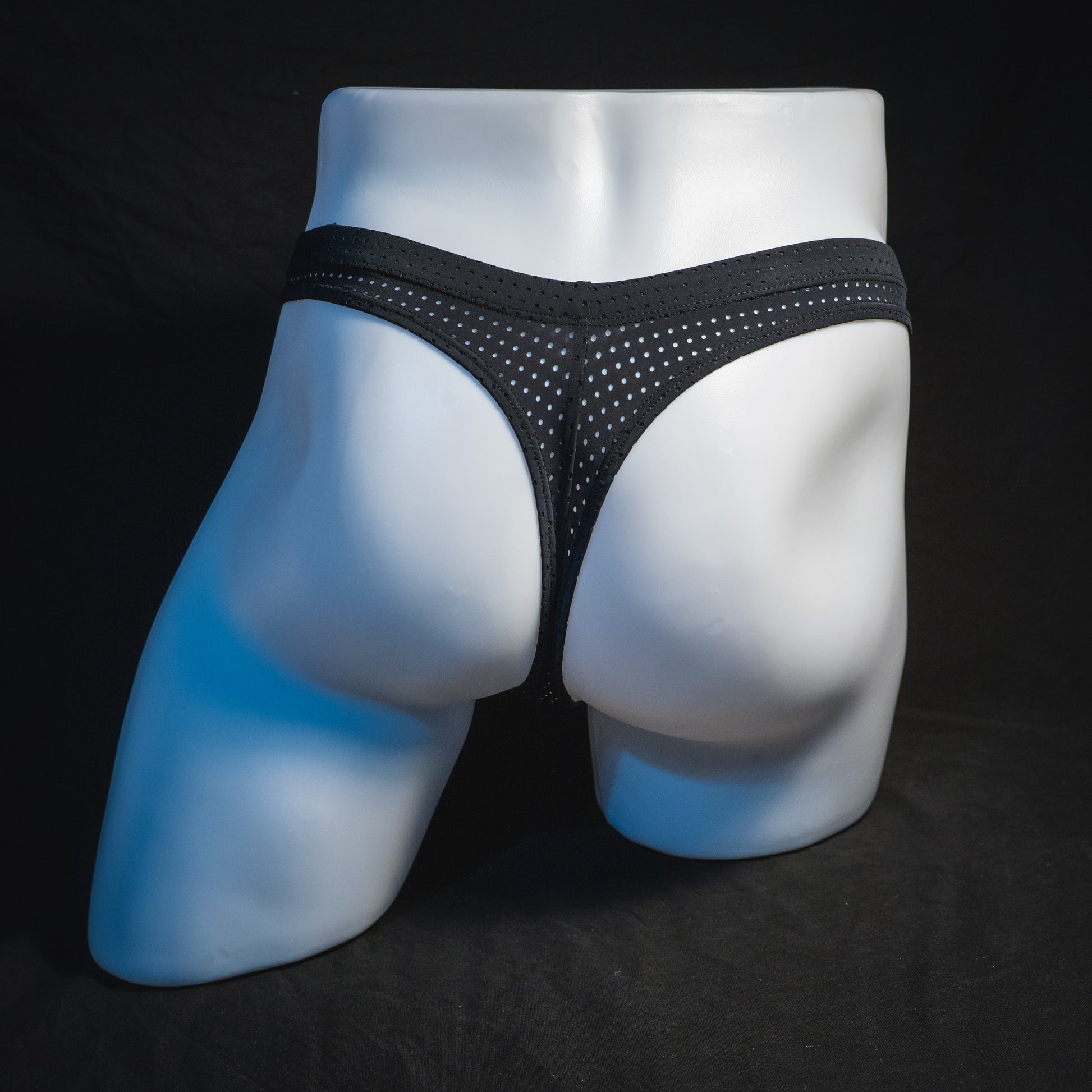 Men's black mesh pre-release thong underwear, full rear view.