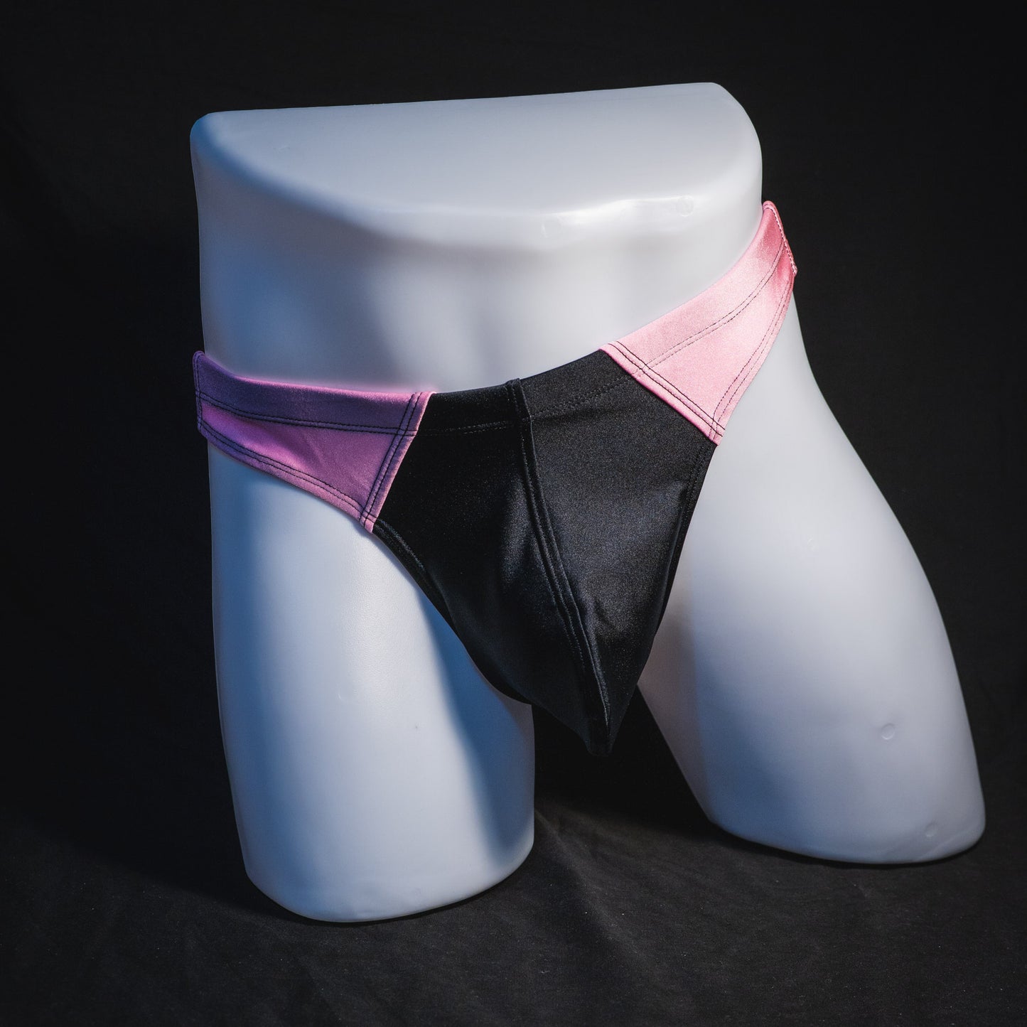 Men's pink and black thong underwear. contour cut, full front view.