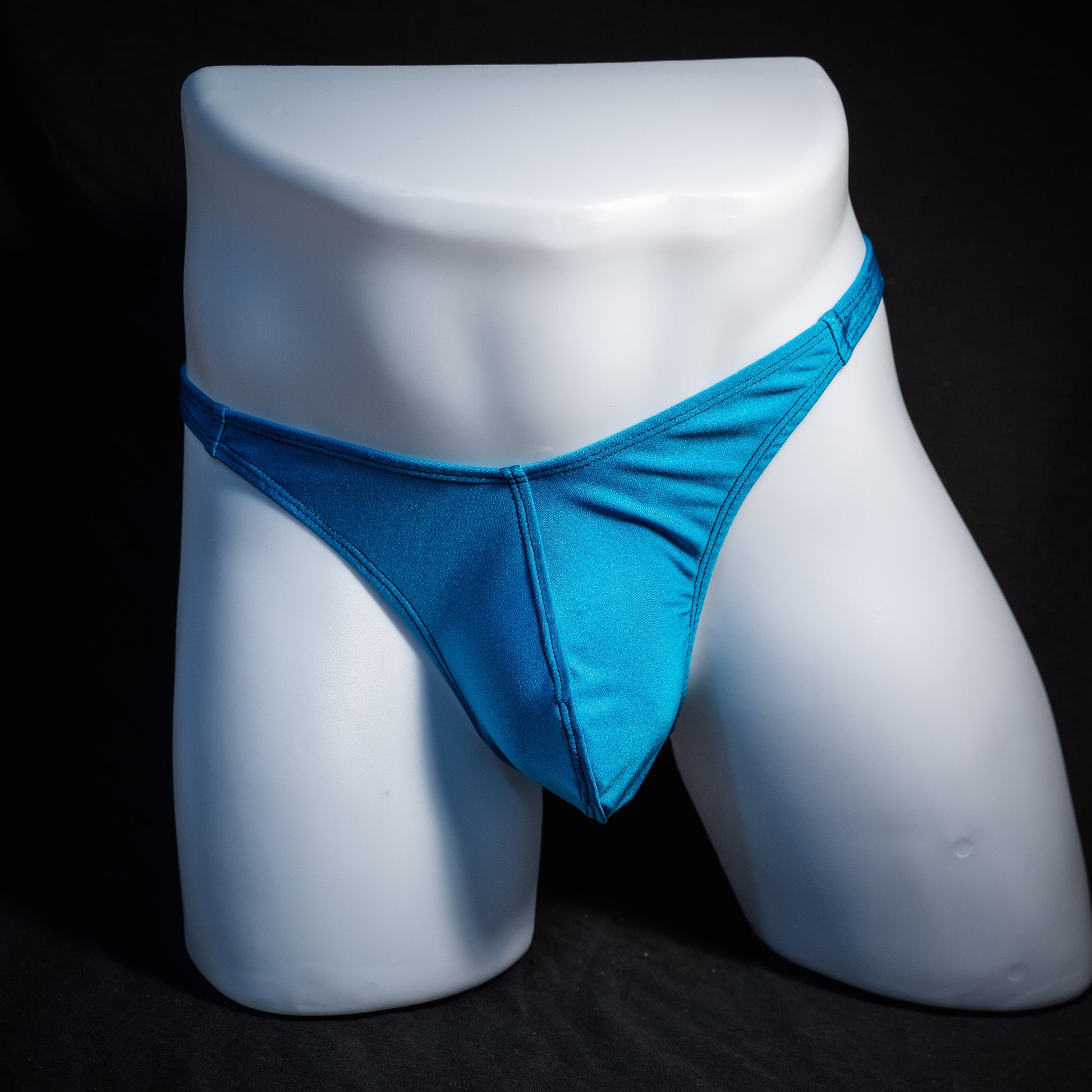 Men's teal blue thong underwear, classic cut, front view.
