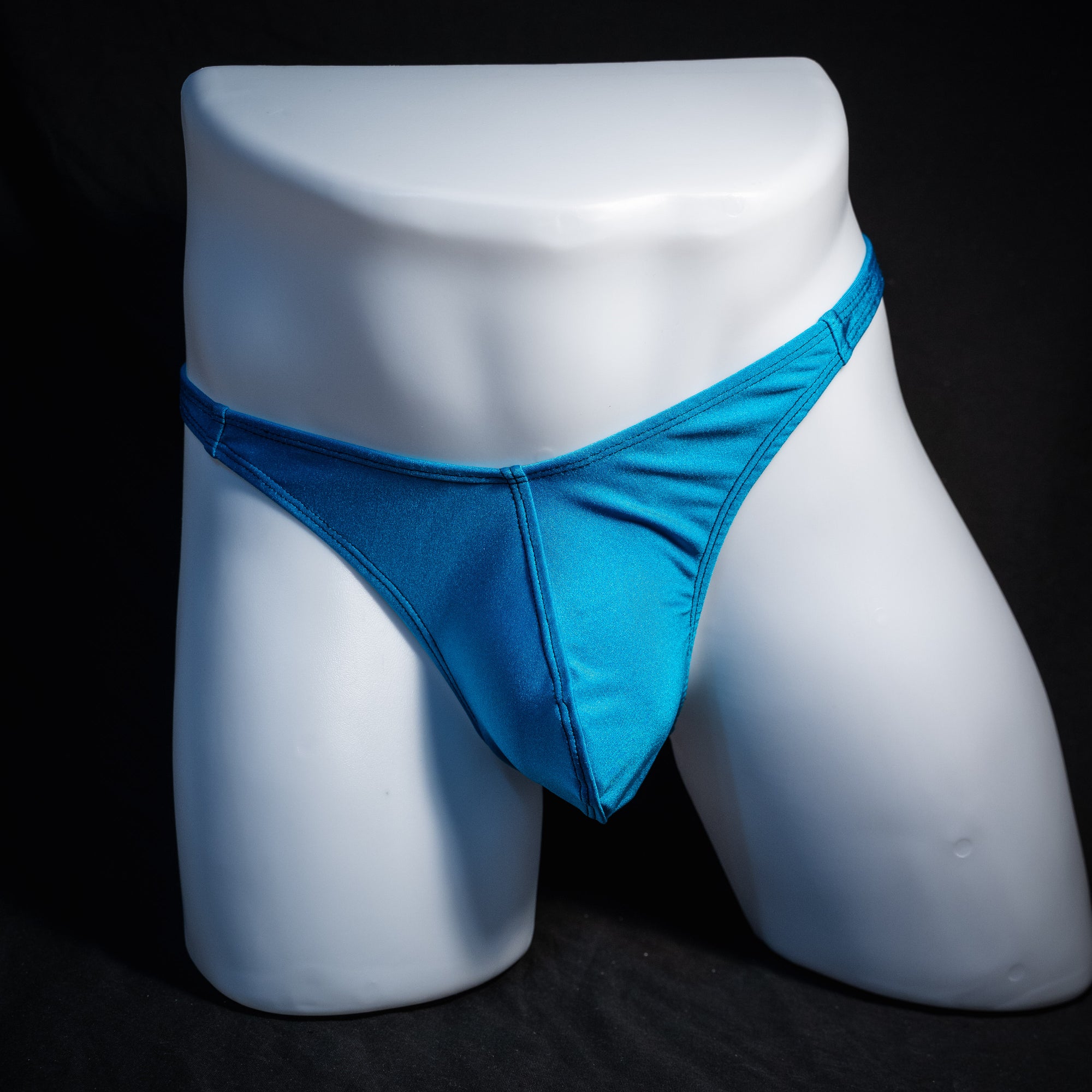 Men's teal blue thong underwear, classic cut, front view.