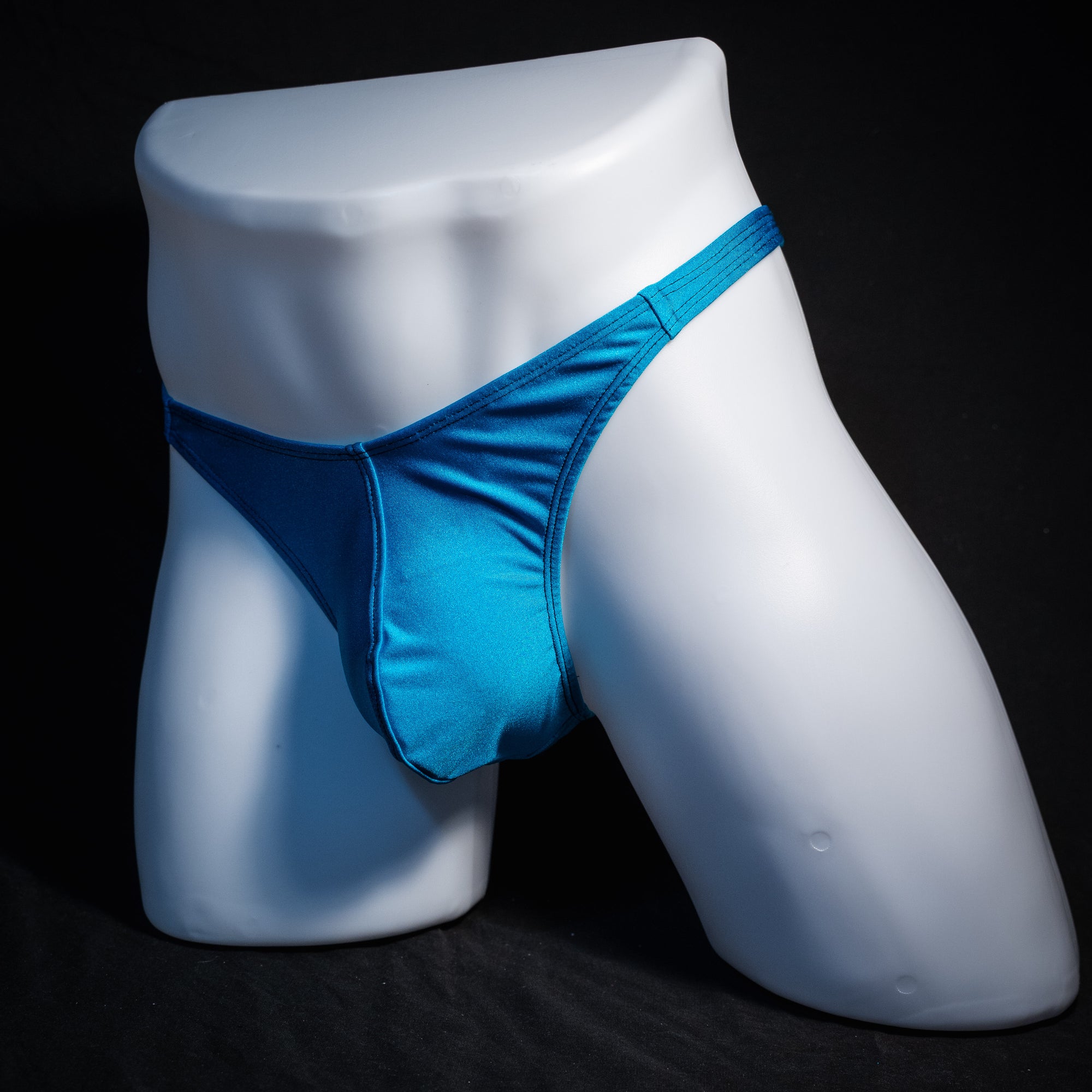 Men's teal blue thong underwear, classic cut, front view.
