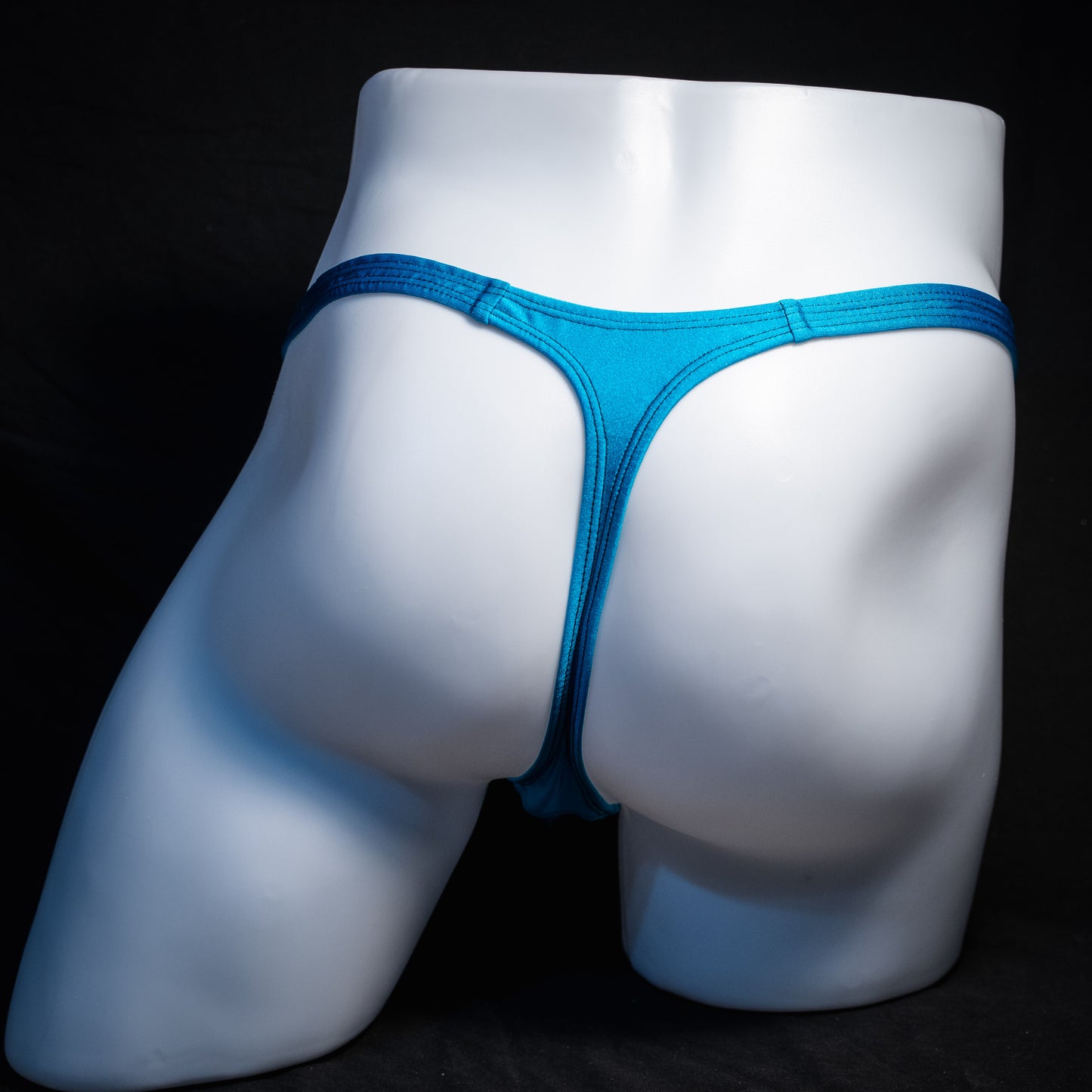 Men's teal blue thong underwear, classic cut, rear view.