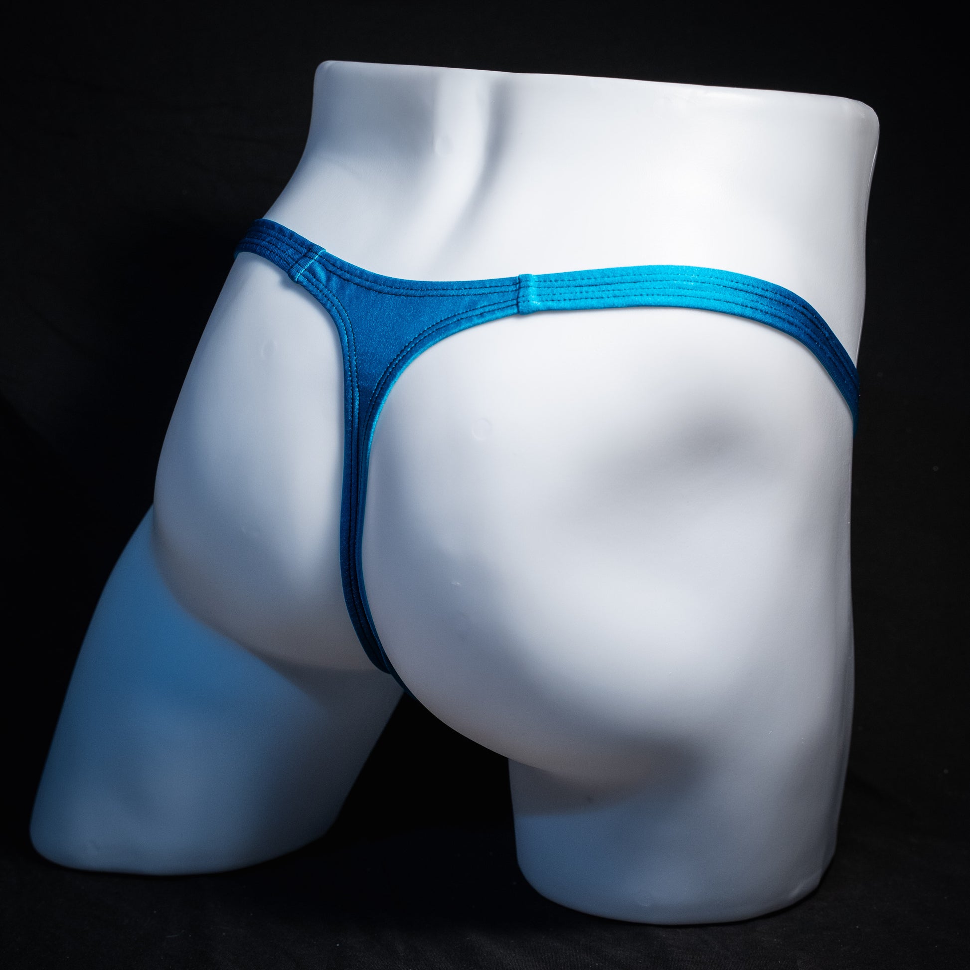 Men's teal blue thong underwear, classic cut, rear view.