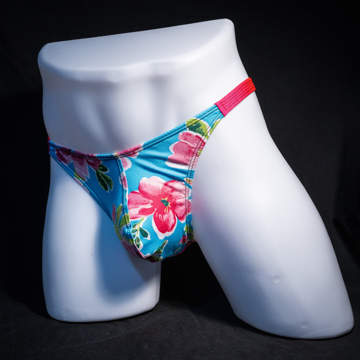 Men's blue with pink flowers thong underwear, classic cut, front view.