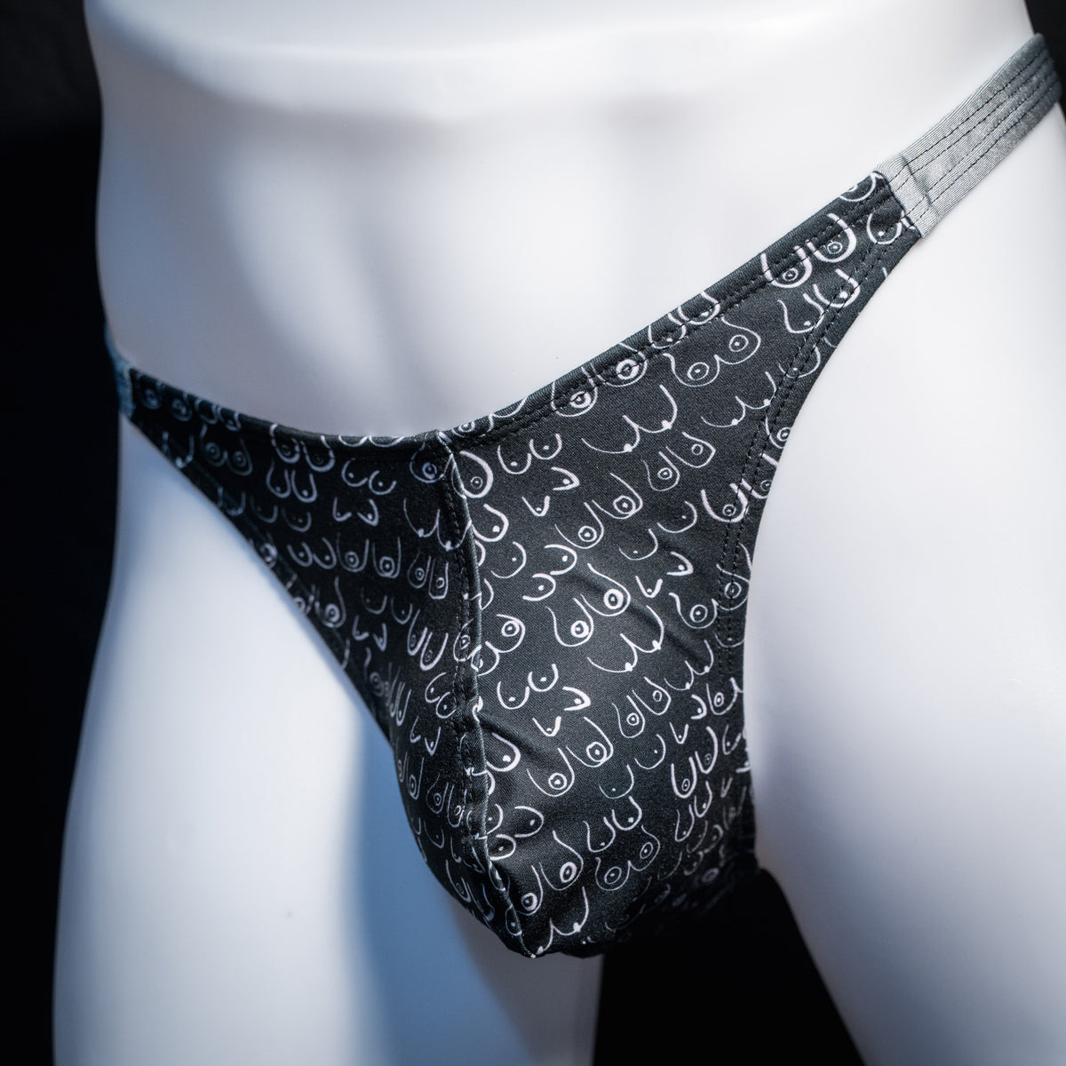 Men's boob patterned thong underwear, classic cut, front view.