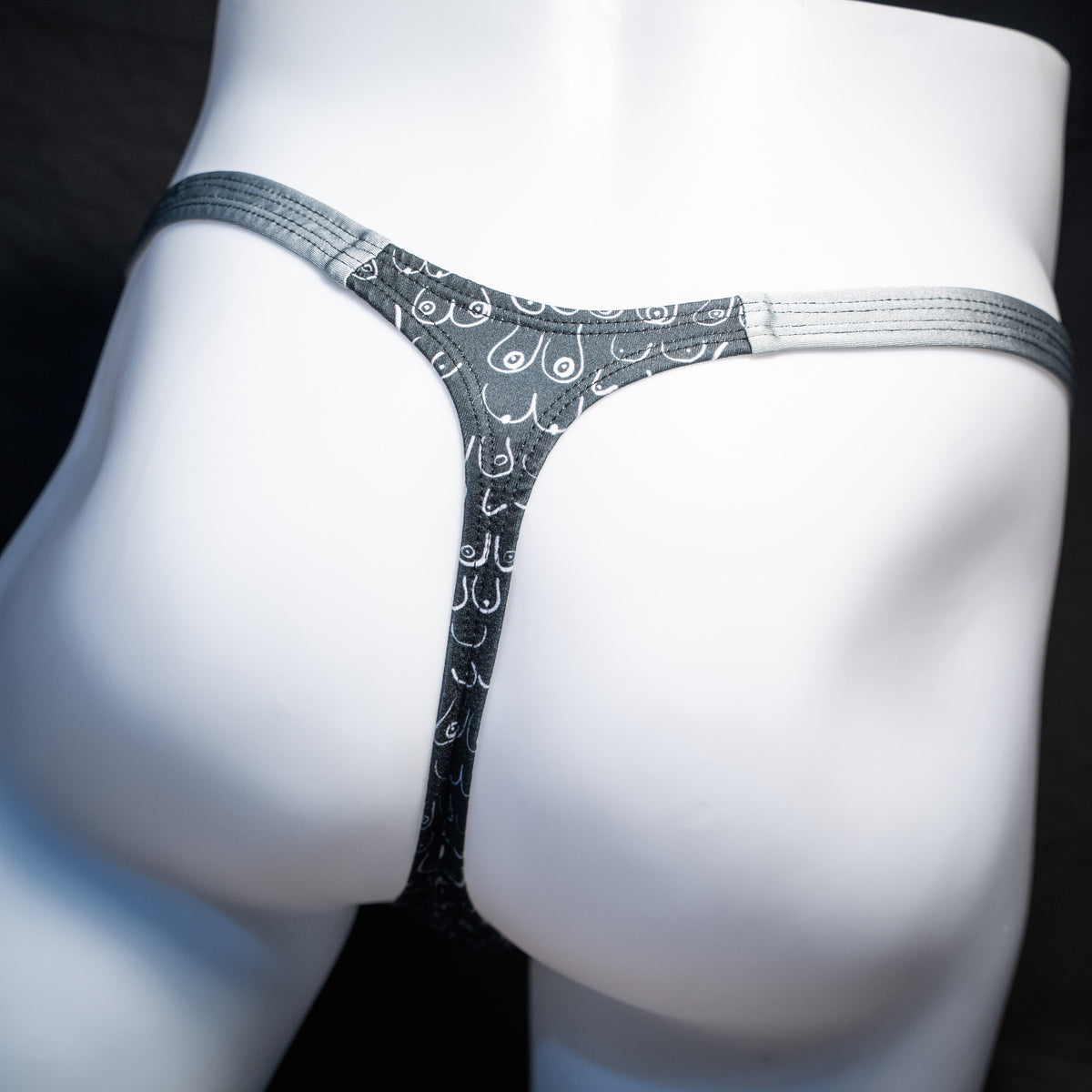 Men's boob patterned thong underwear, classic cut, rear view.