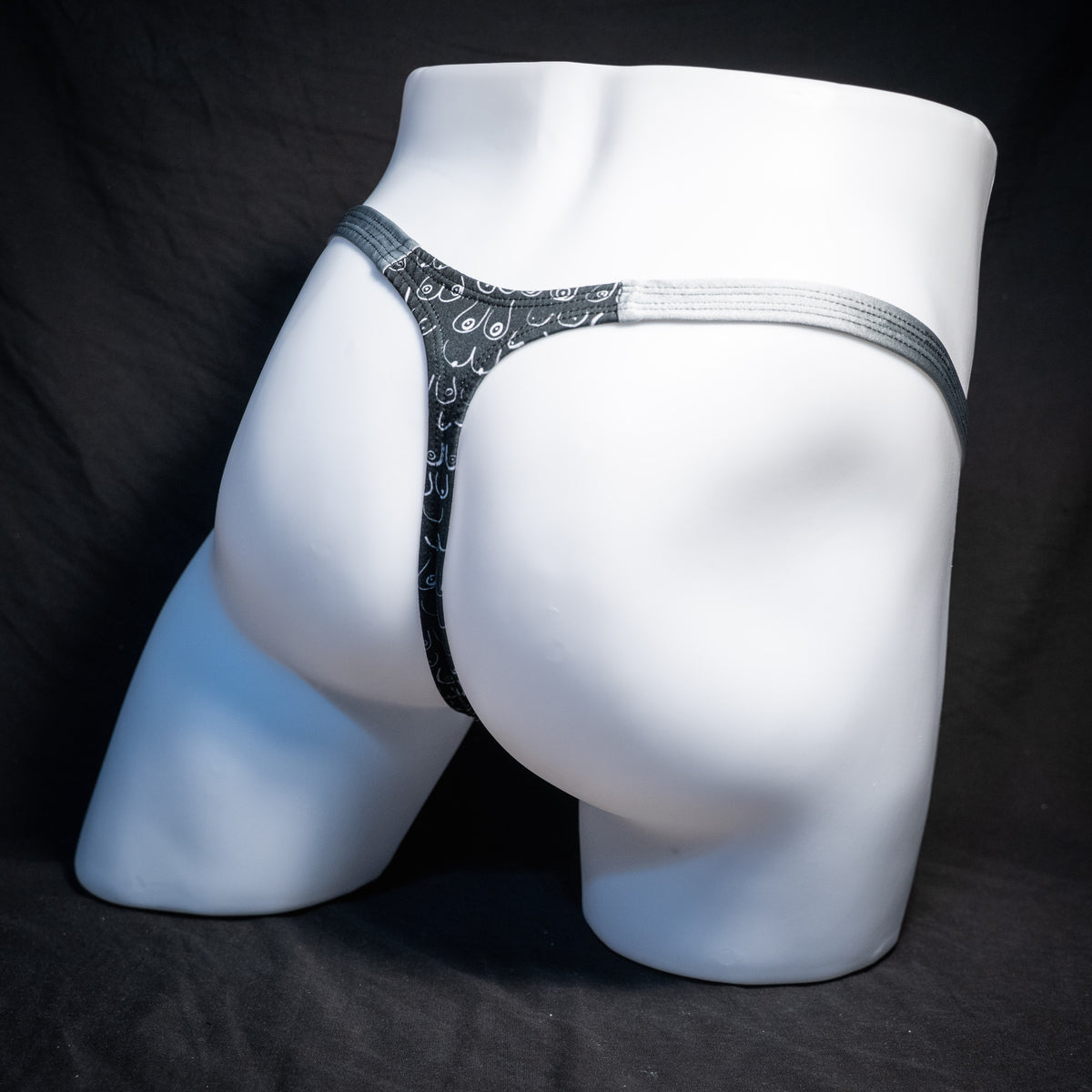 Men's boob patterned thong underwear, classic cut, rear view.