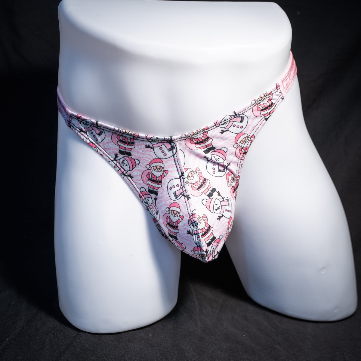 Men's pink Santa's and snowmen, Christmas themed thong underwear, classic cut, front view.