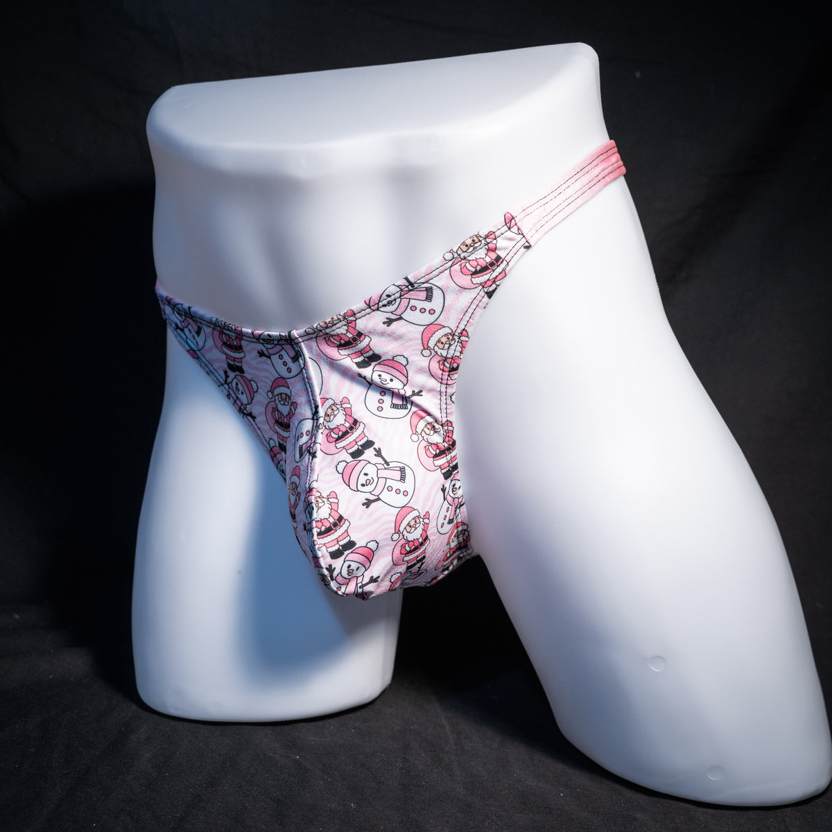 Men's pink Santa's and snowmen, Christmas themed thong underwear, classic cut, front view.