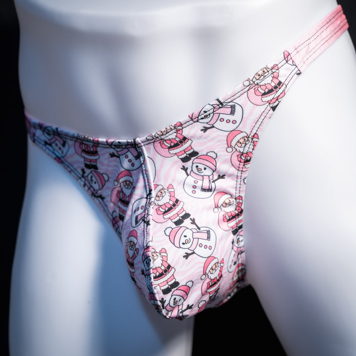Men's pink Santa's and snowmen, Christmas themed thong underwear, classic cut, front view.
