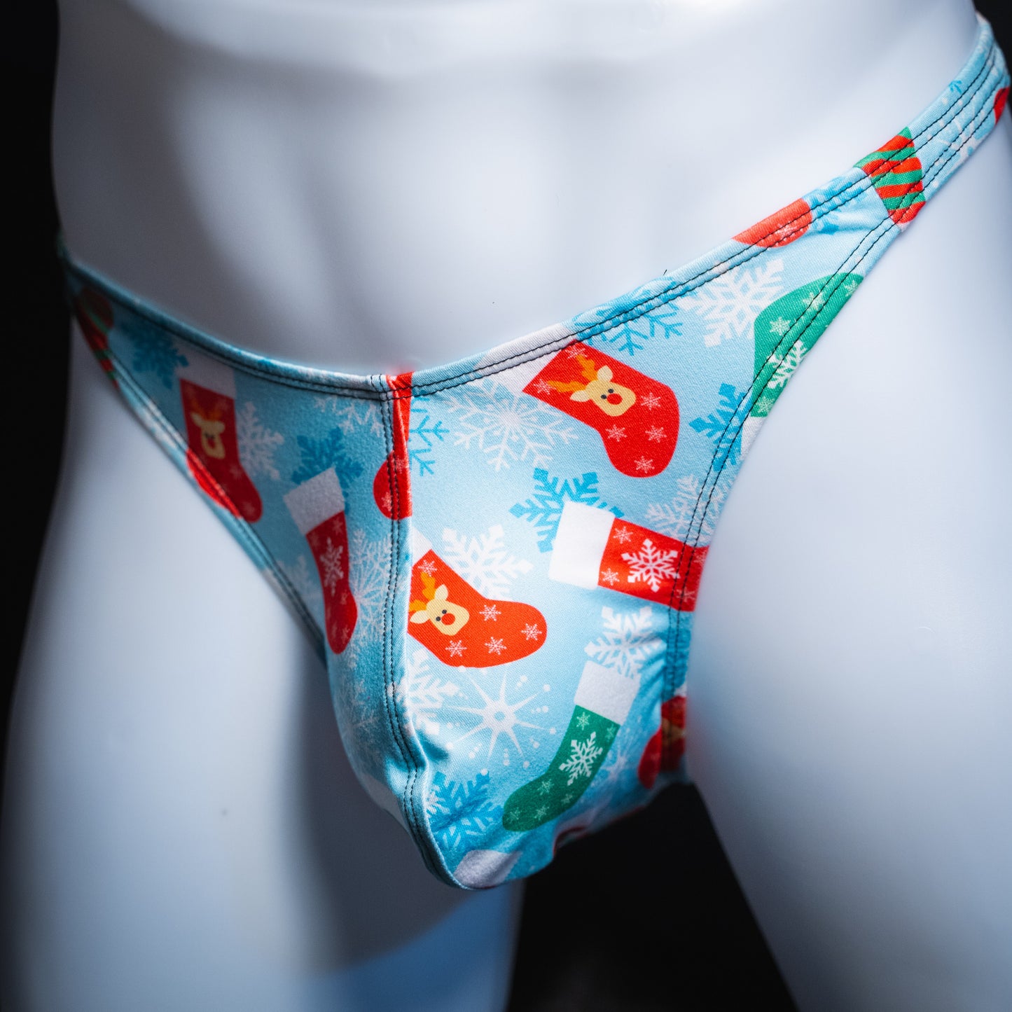 Men's Christmas stocking thong underwear, Classic cut, angled front view.