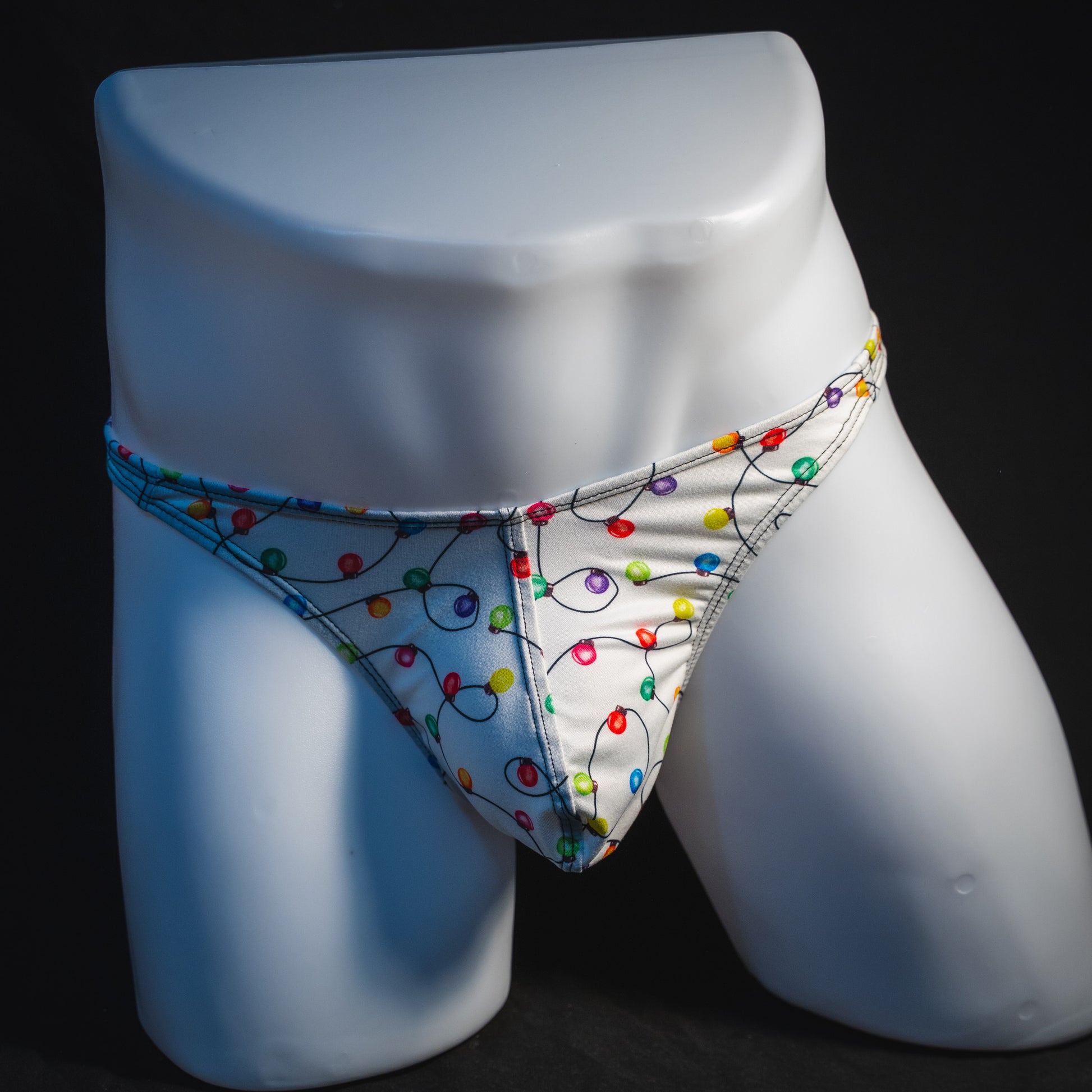 Men's Christmas lights thong underwear, full front view.