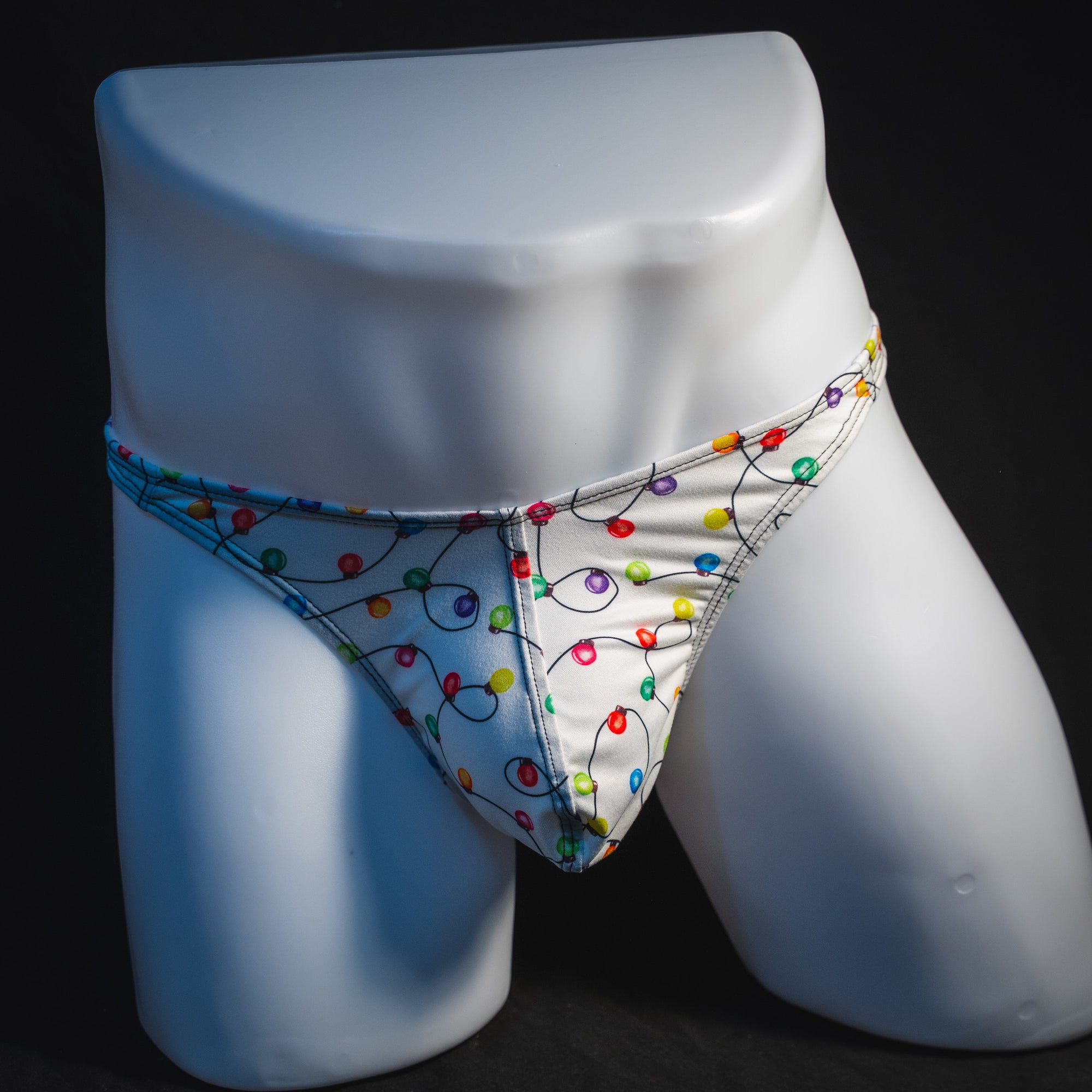Men's Christmas lights thong underwear, full front view.