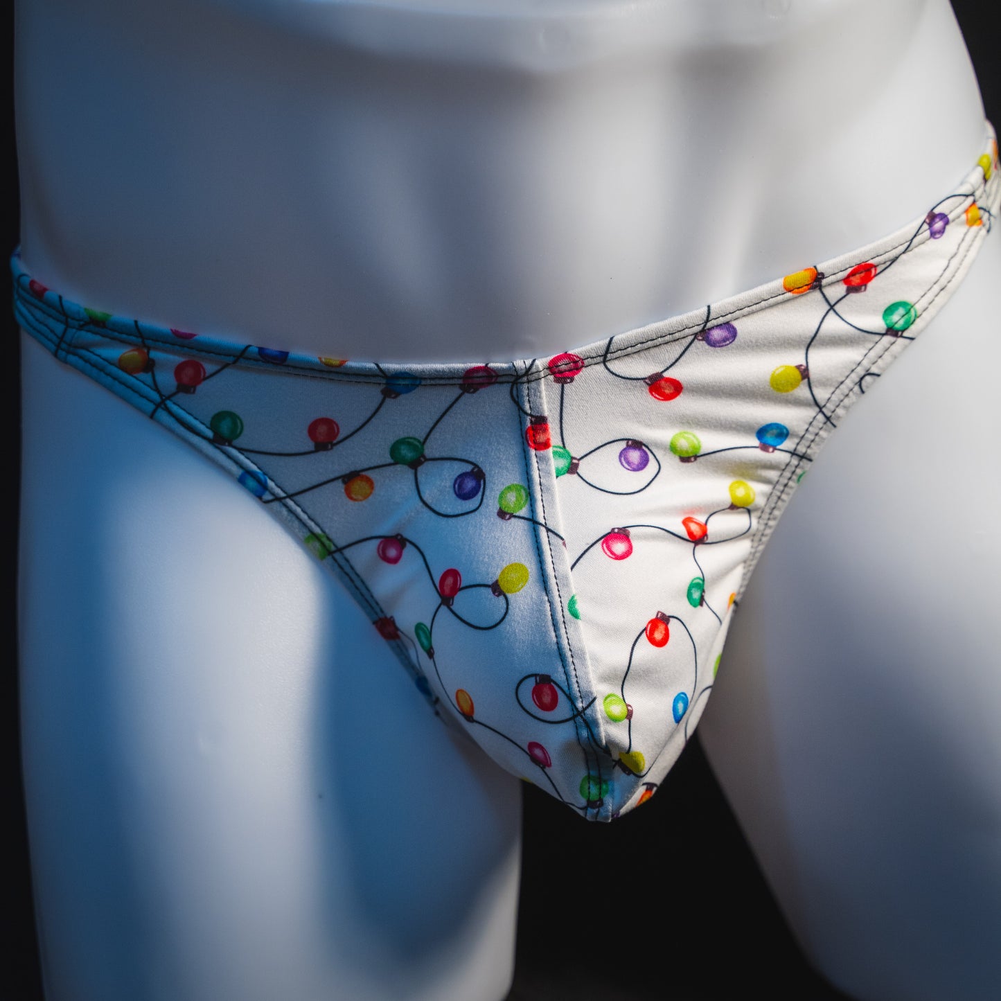 Men's Christmas lights thong underwear, front view.