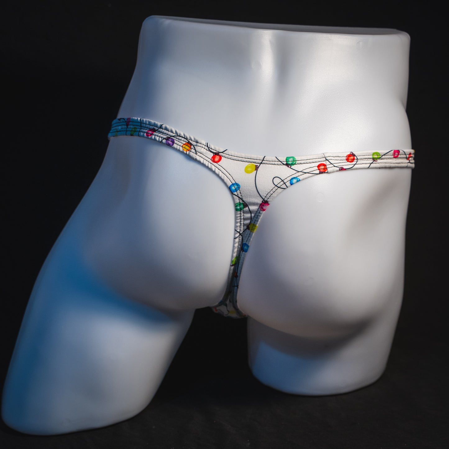 Men's Christmas lights thong underwear, full rear view.