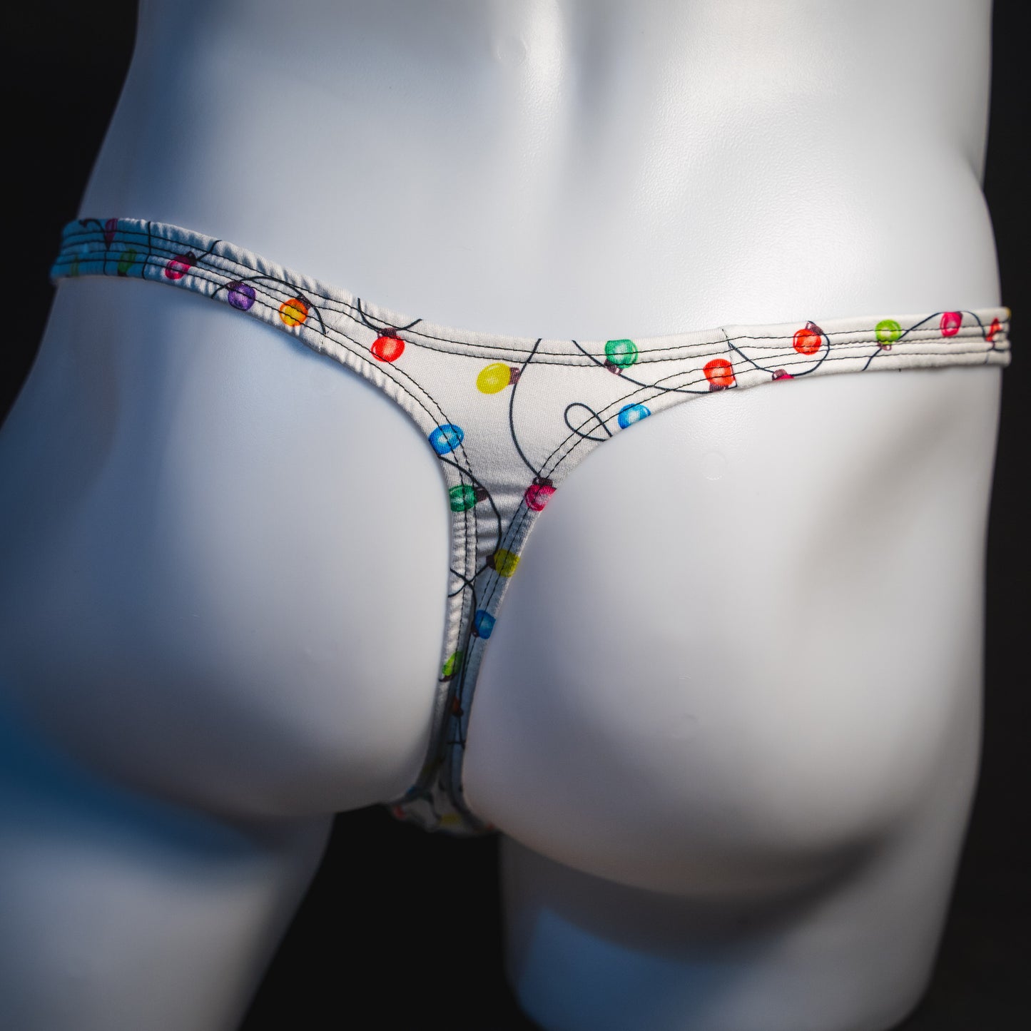 Men's Christmas lights thong underwear, rear view.