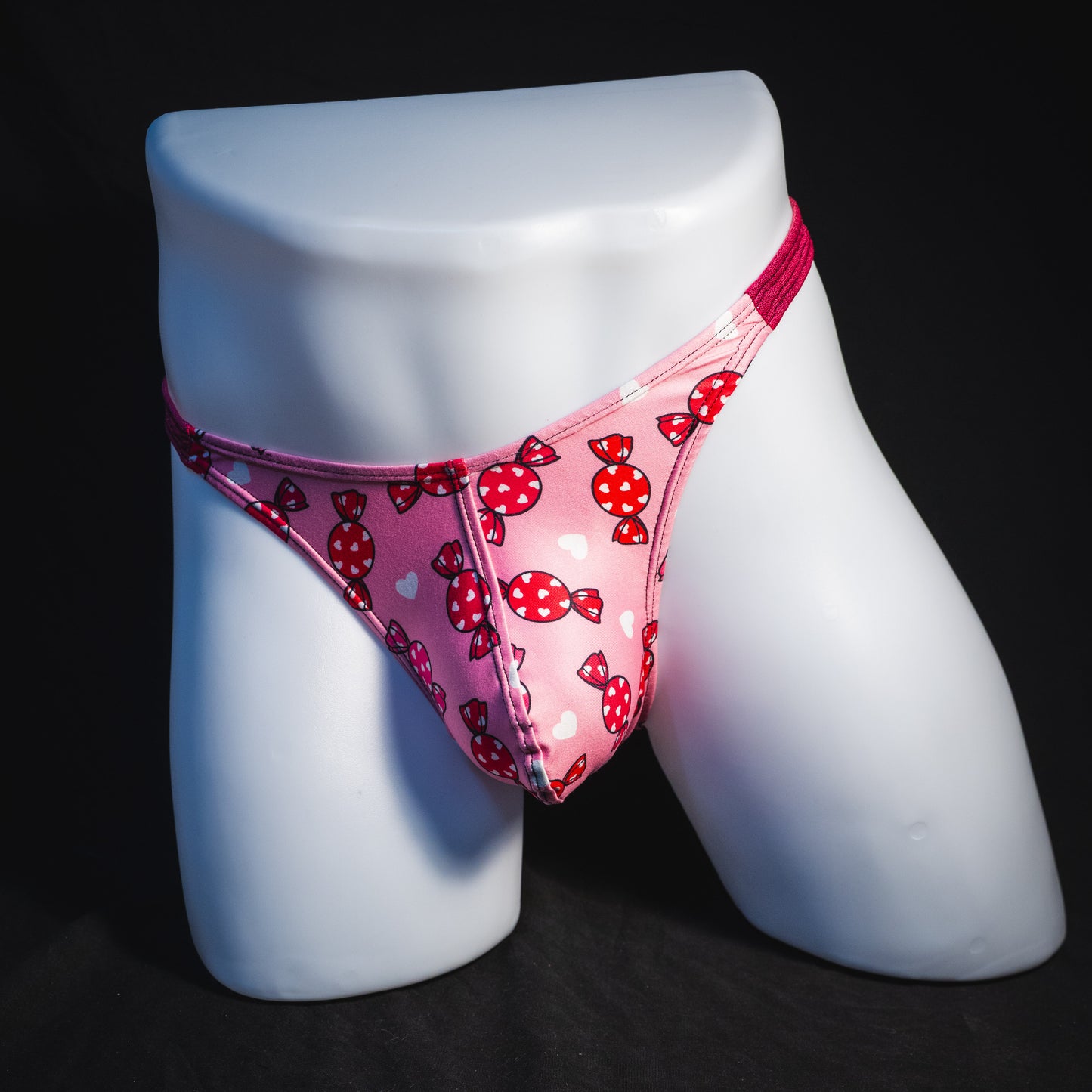 Men's Valentine Days candies with pink metallic straps thong underwear, classic cut, full front view.